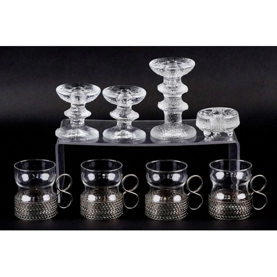 Four Finnish glass candlesticks and a set of four designer g...