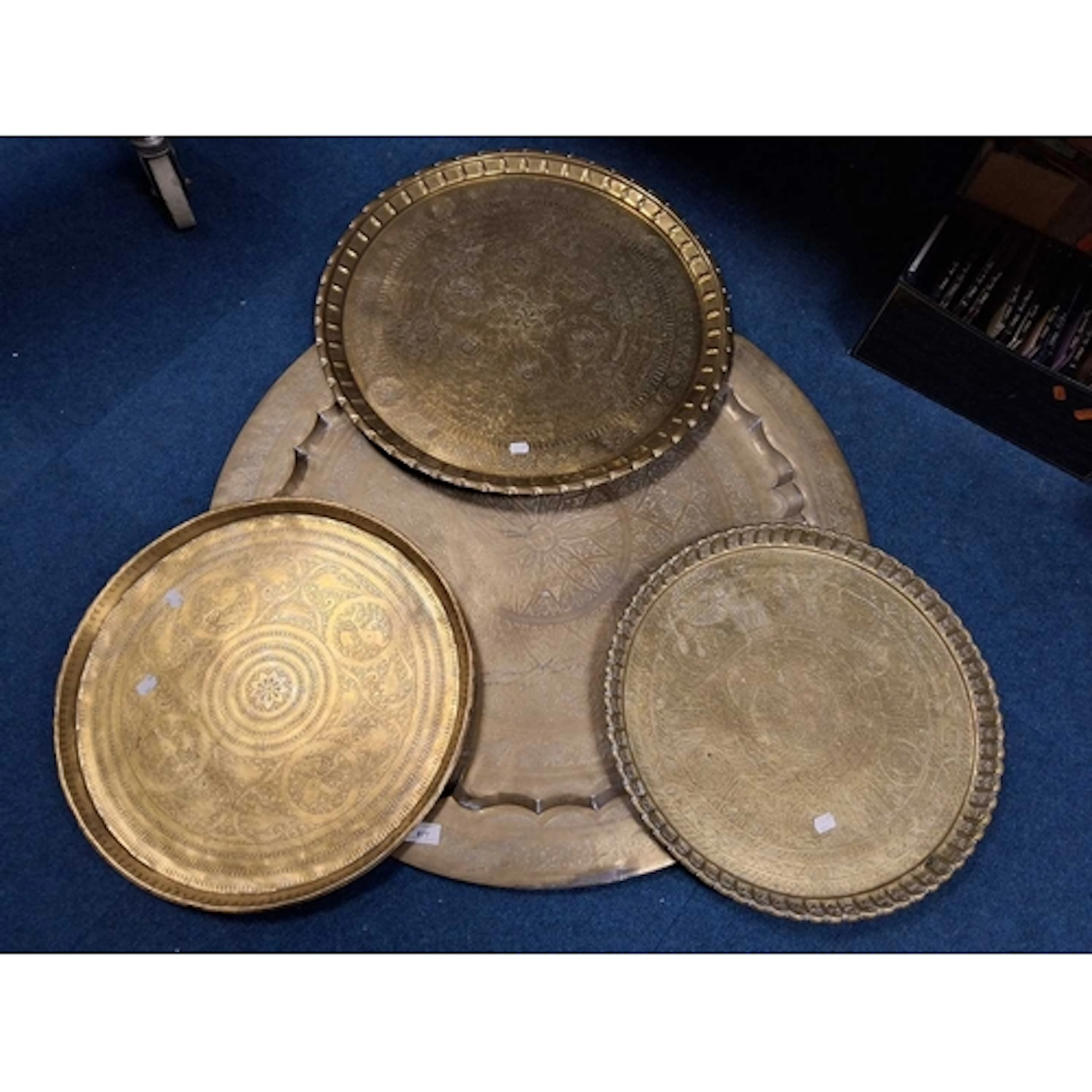 FOUR LARGE BRASS MIDDLE EASTERN STYLE CHARGERS, each with in...