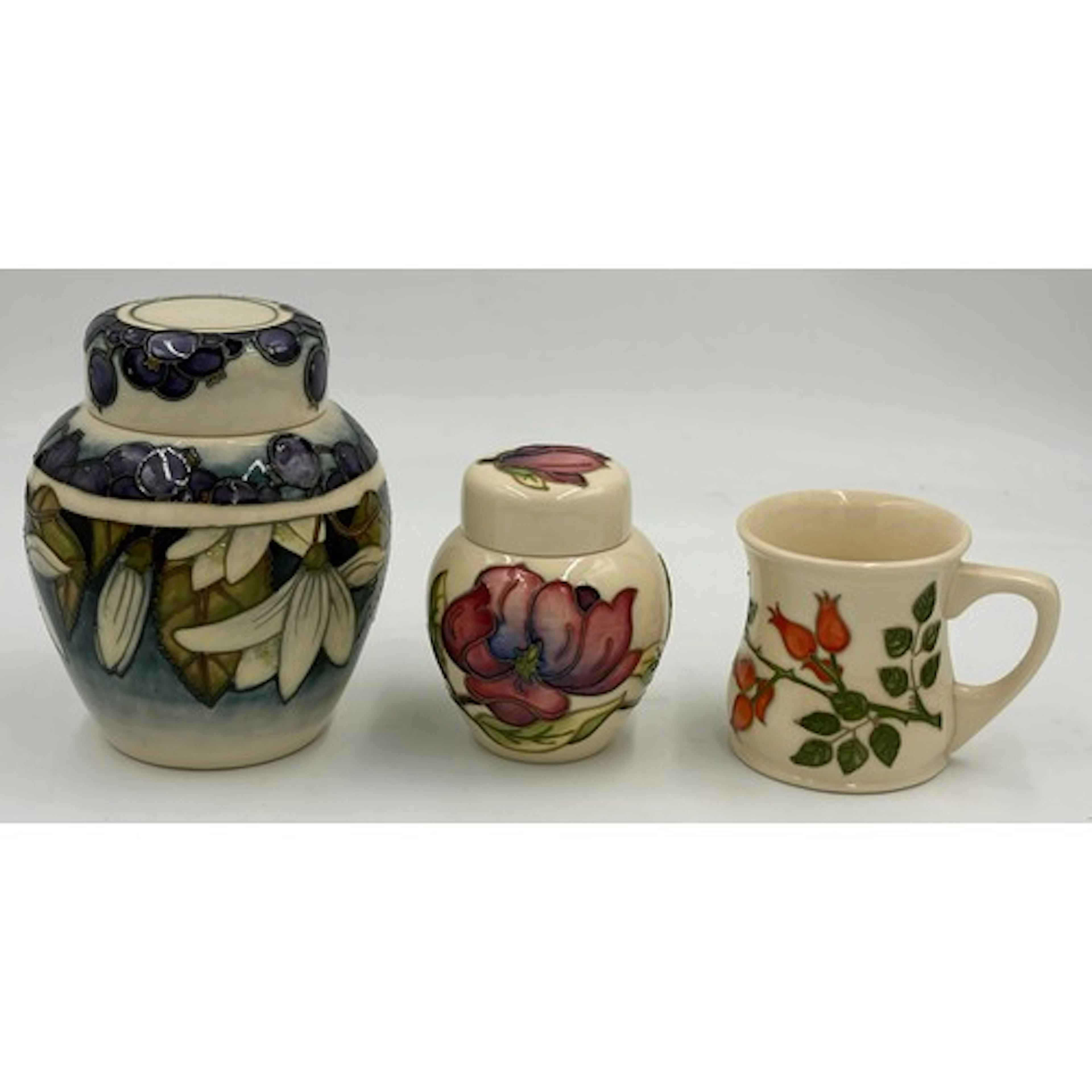 A collection of Moorcroft pottery to include Juneberry ginge...