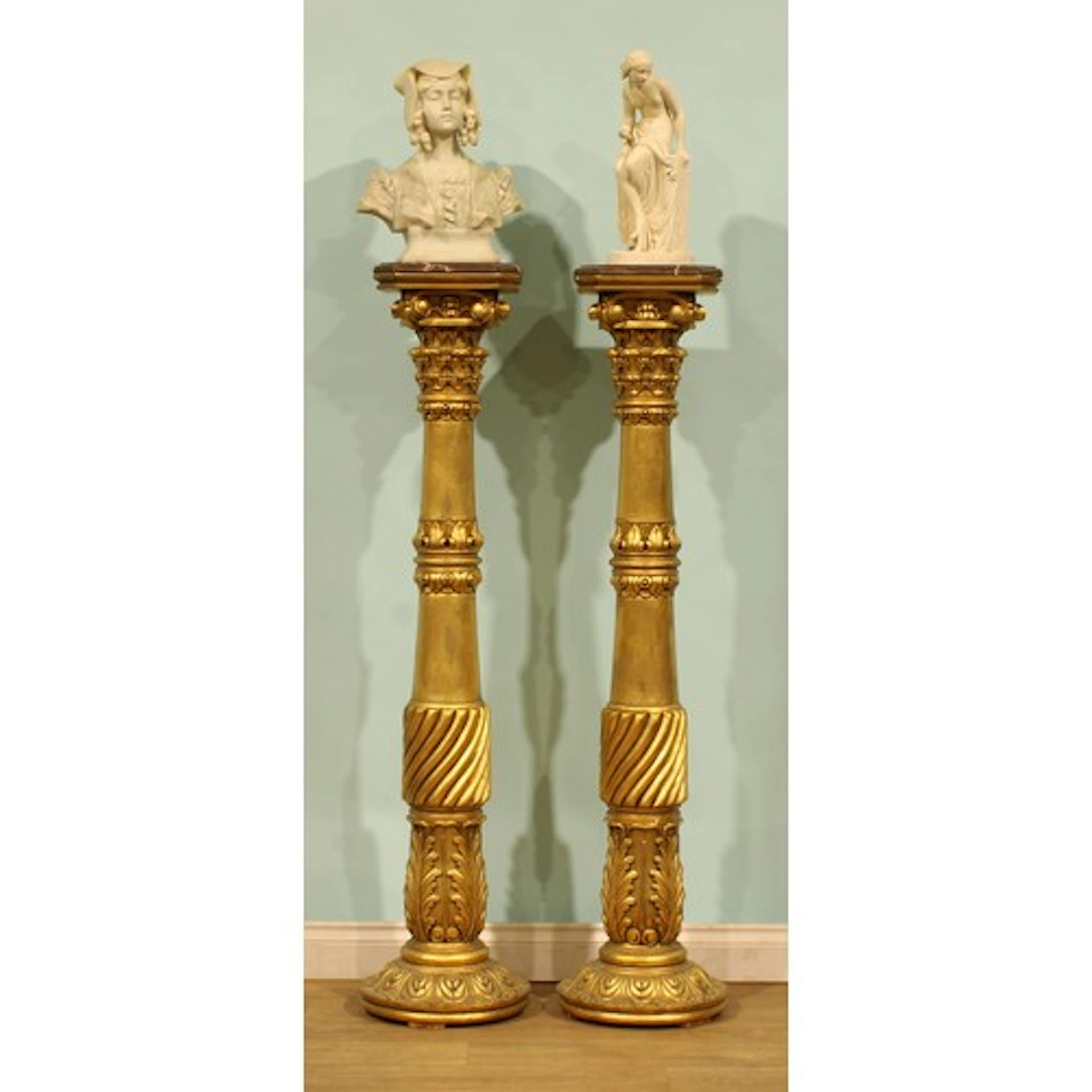 A pair of contemporary Neoclassical design giltwood statuary...