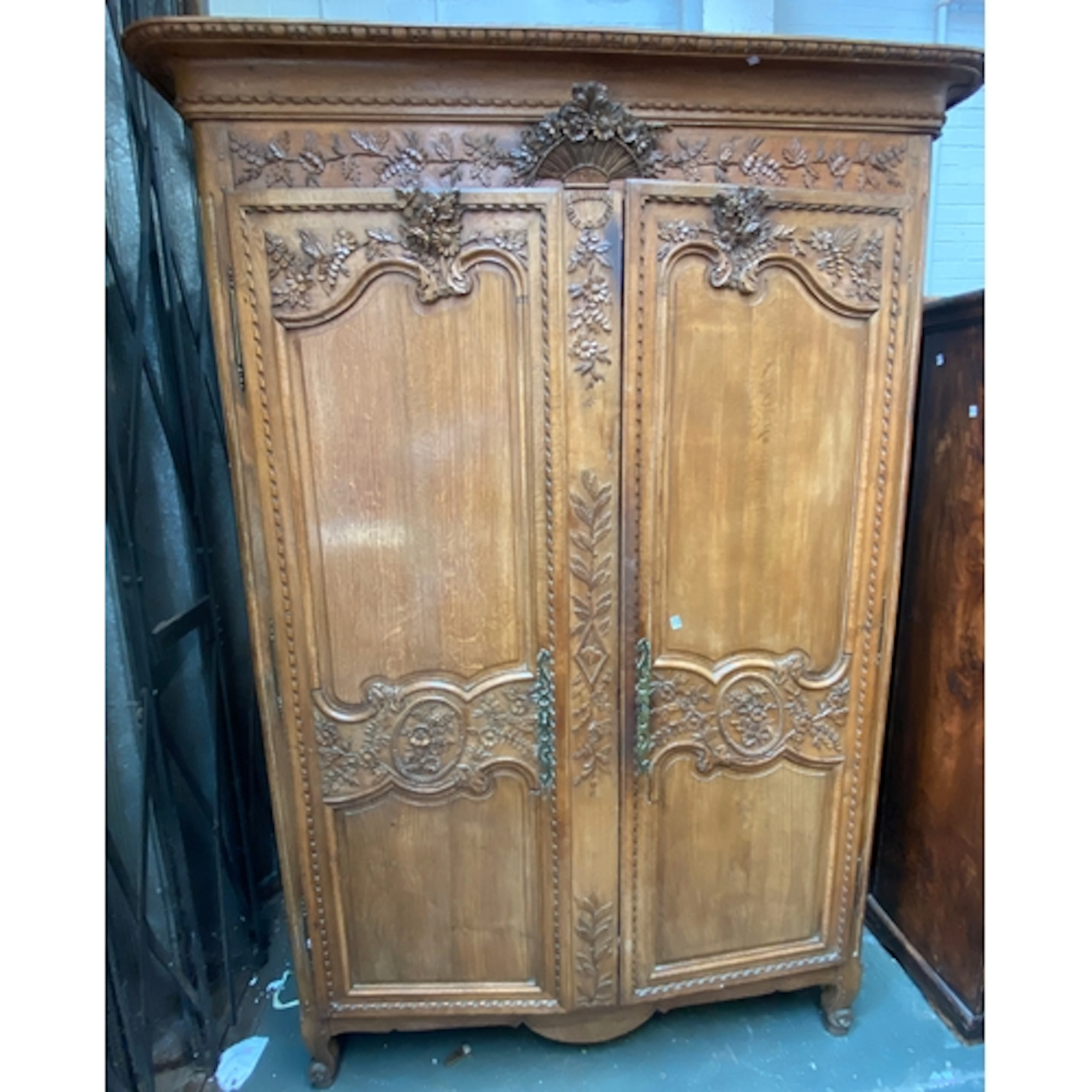 A large 19th century French armoire with carved pediment and...