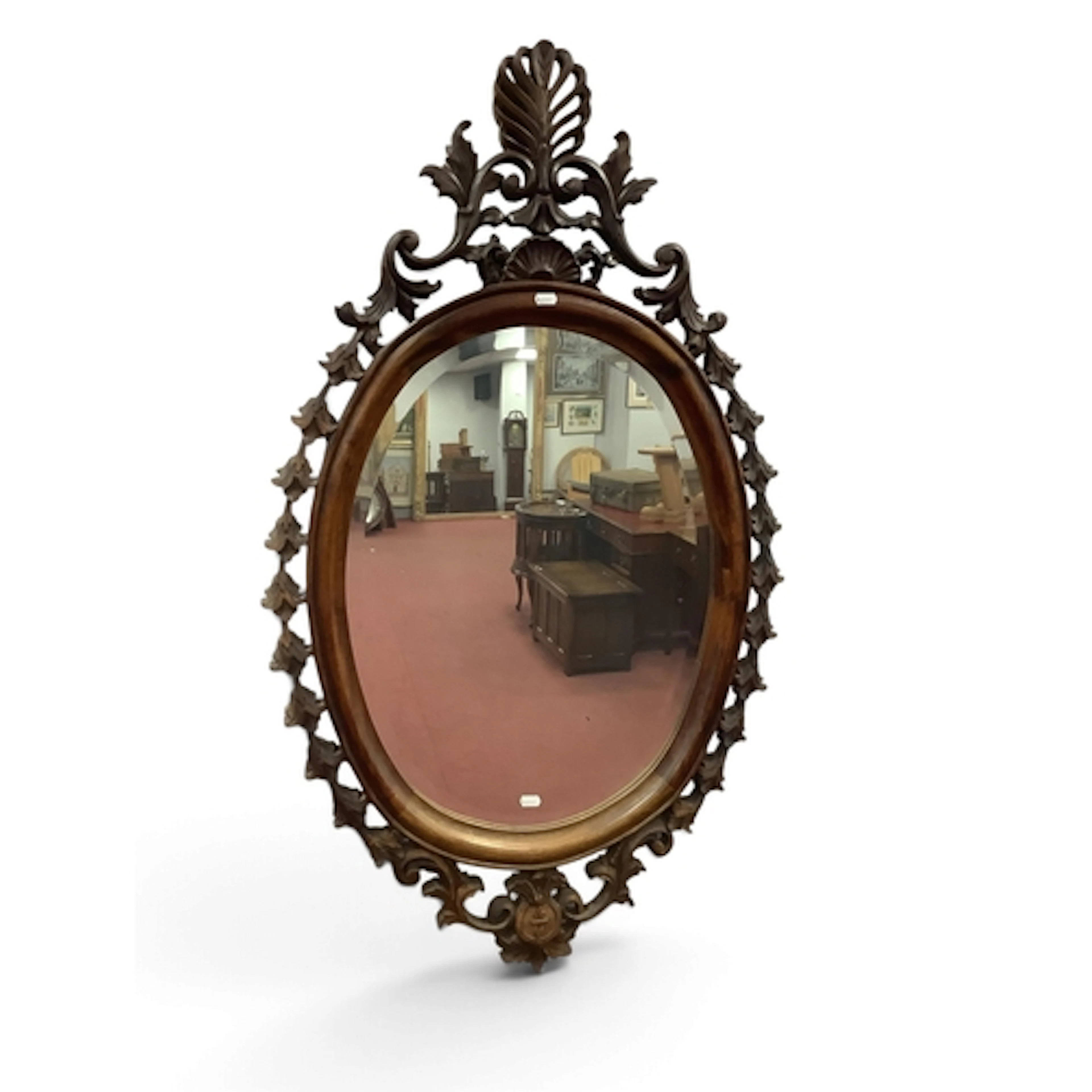A Vintage Carved Walnut Wall Mirror, featuring an oval bevel...