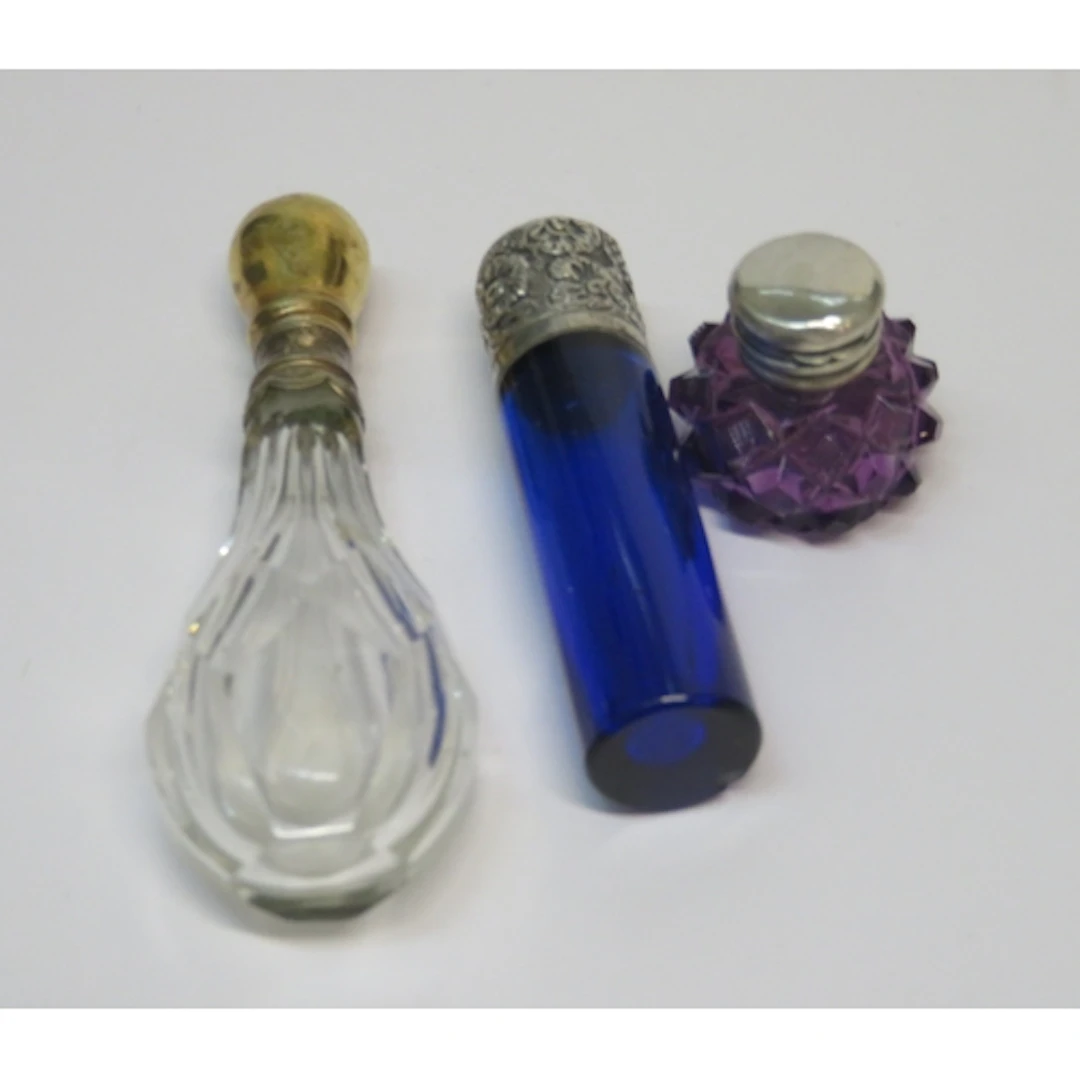 Miniature amethyst glass perfume bottle, a blue glass silver...