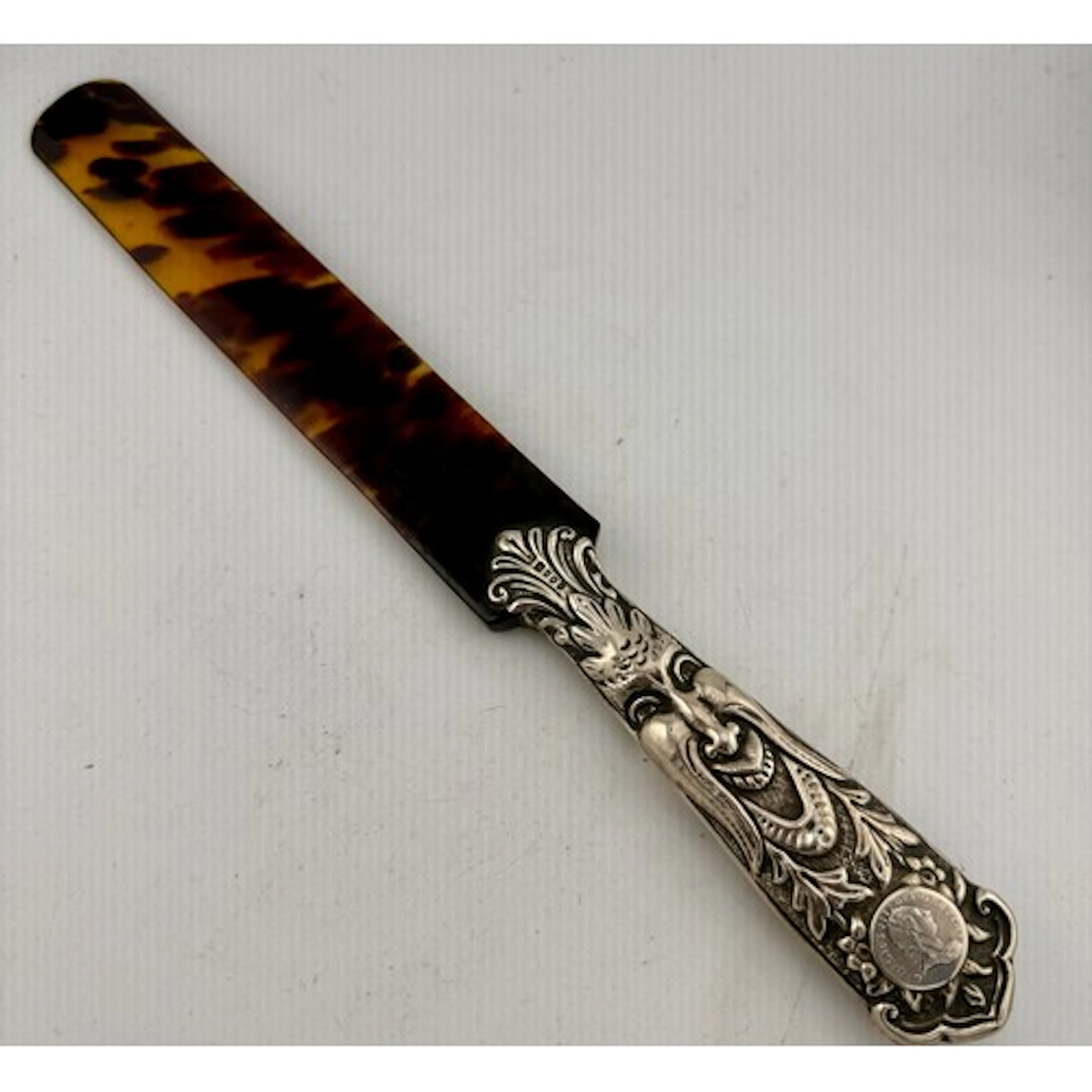 A hallmarked silver and tortoiseshell letter opener. 33cm l....