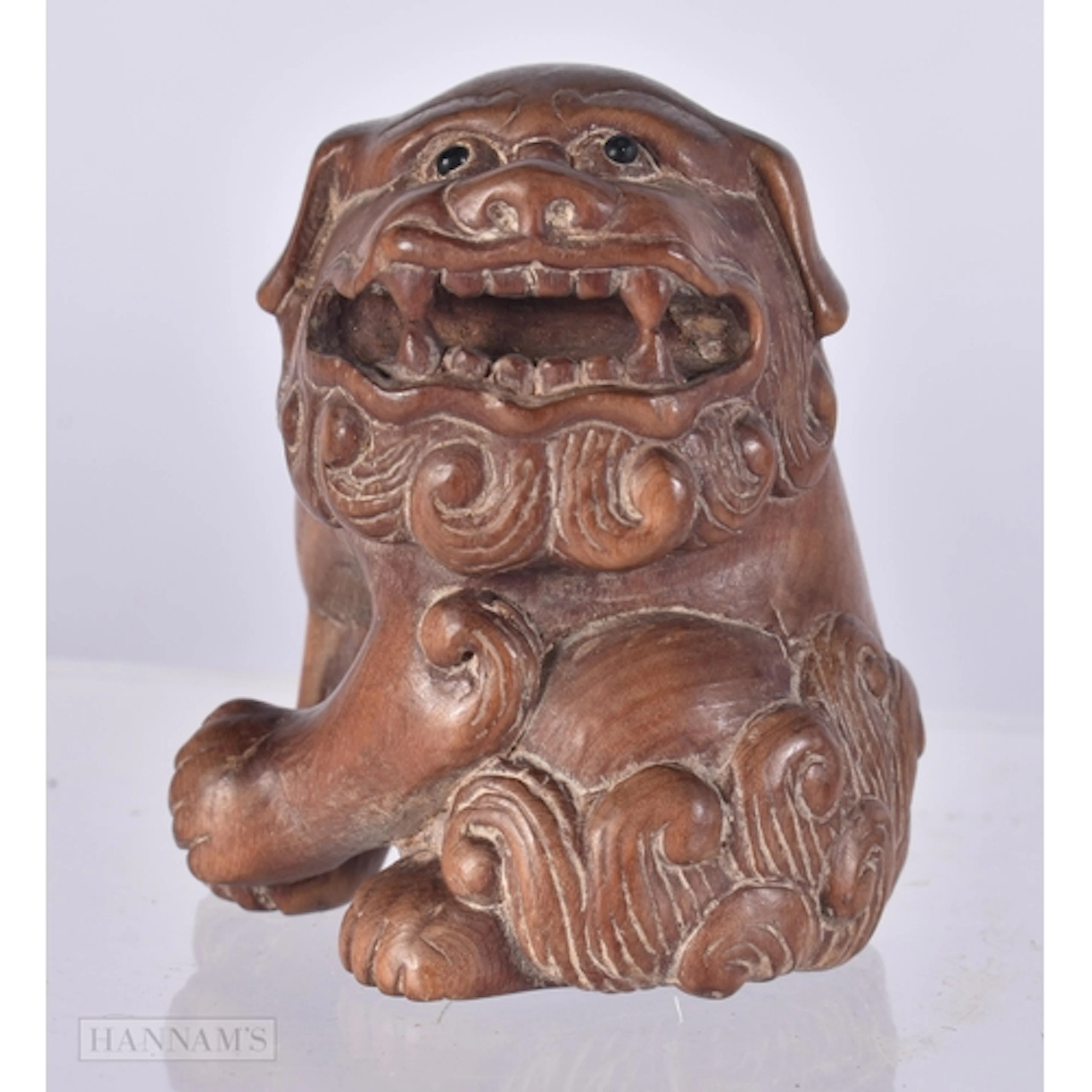 A CARVED WOOD FOO DOG NETSUKE. 4.8 x 4 x 3.5 cm