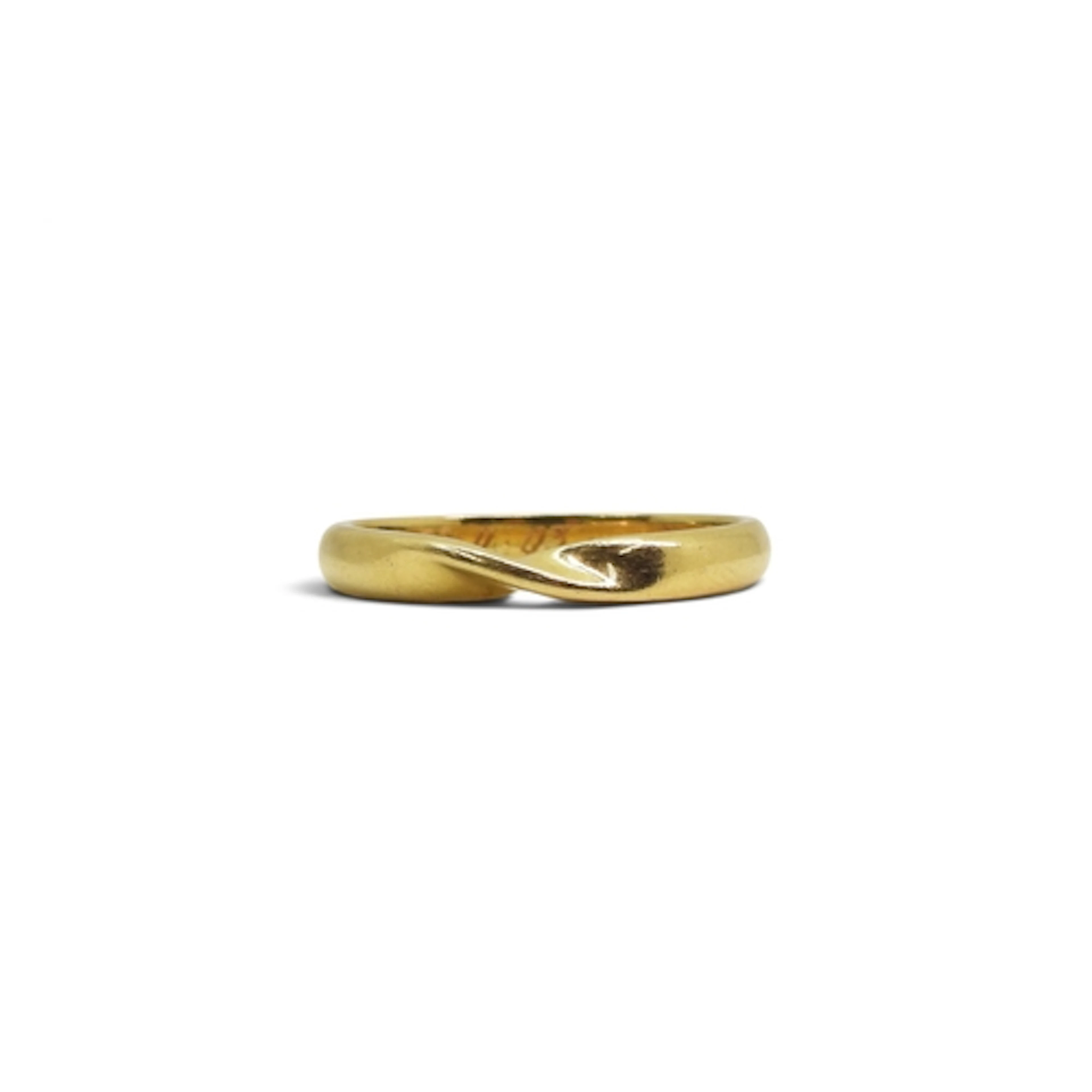 An 18ct gold wedding bang with 'a twist' to fit other rings,...