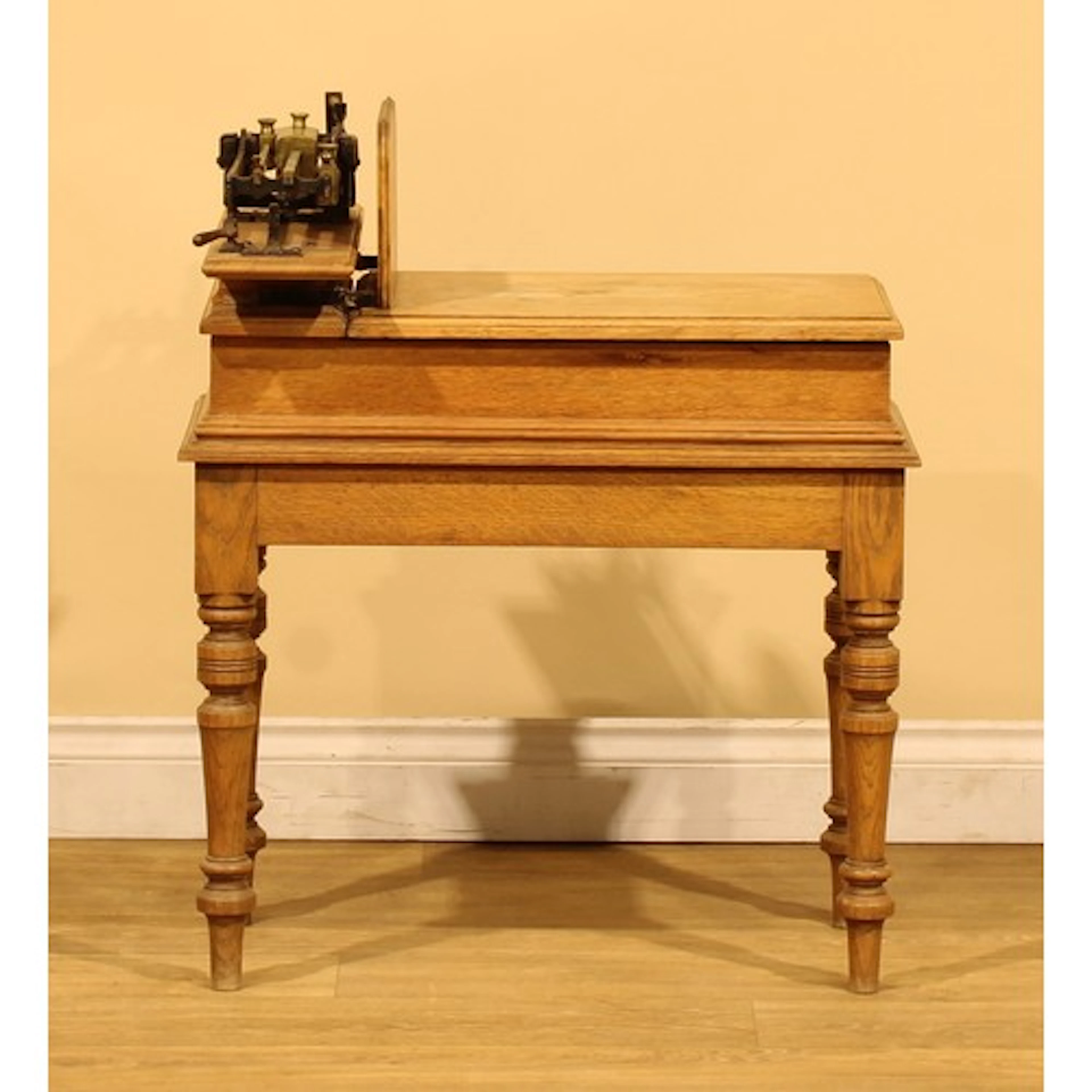 An Arts & Crafts period oak jockey scale, the sliding weight...