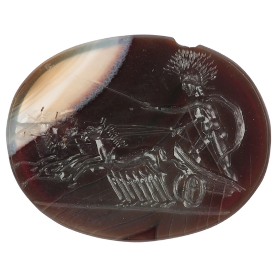 An agate intaglio, carved in the classical style to depict a...