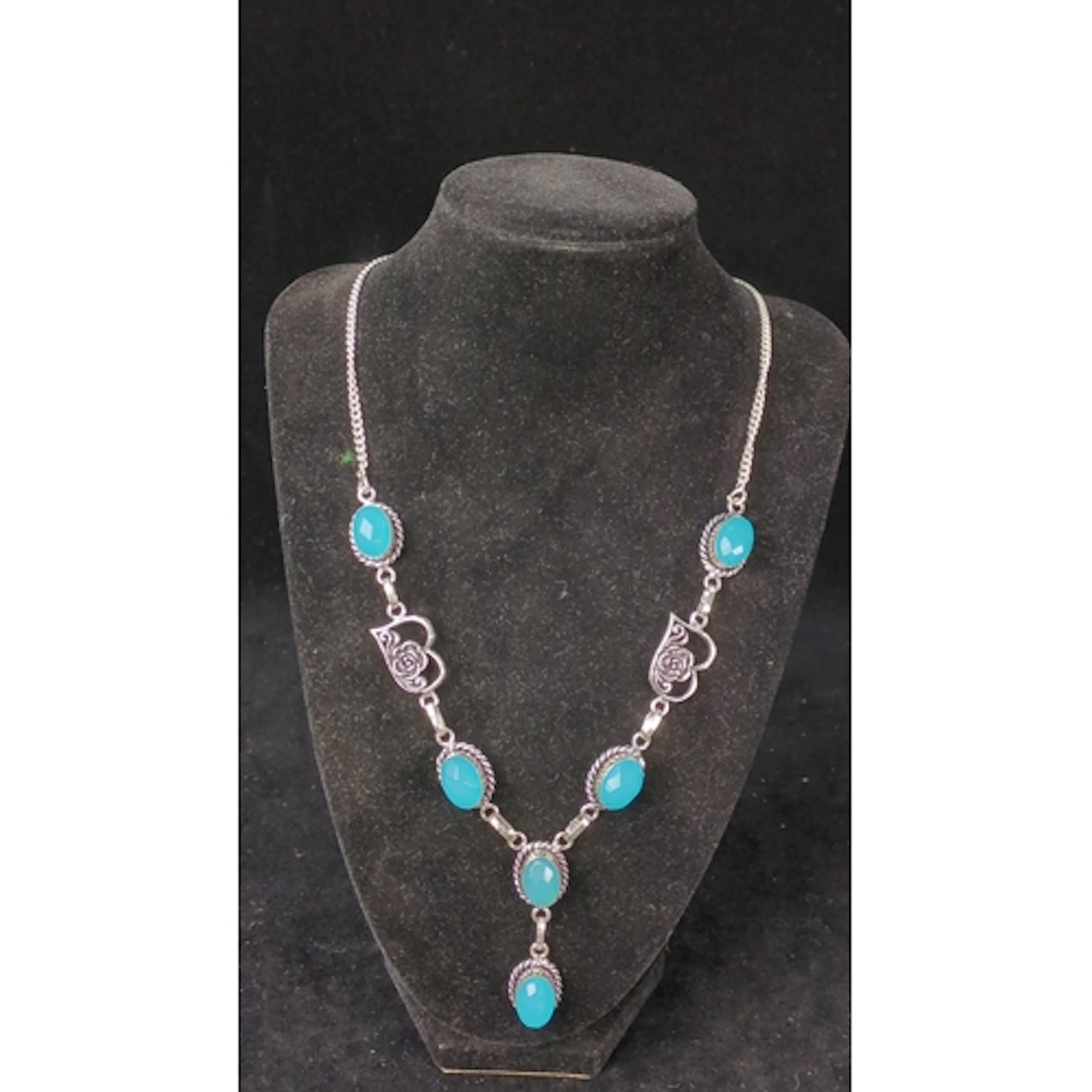 Silver necklace set with turquoise-coloured oval stones in r...