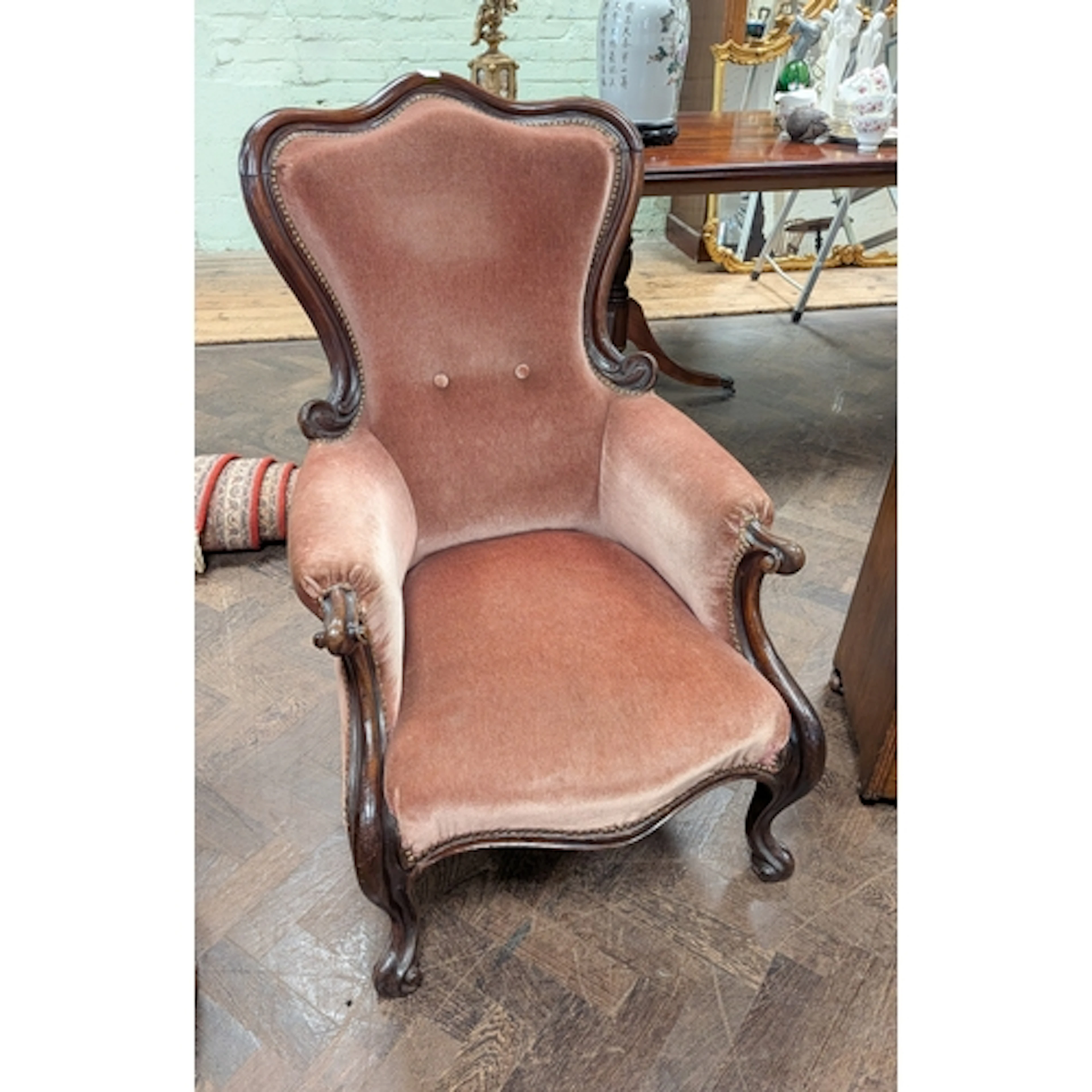 A Victorian mahogany framed ladies armchair with pink uphols...