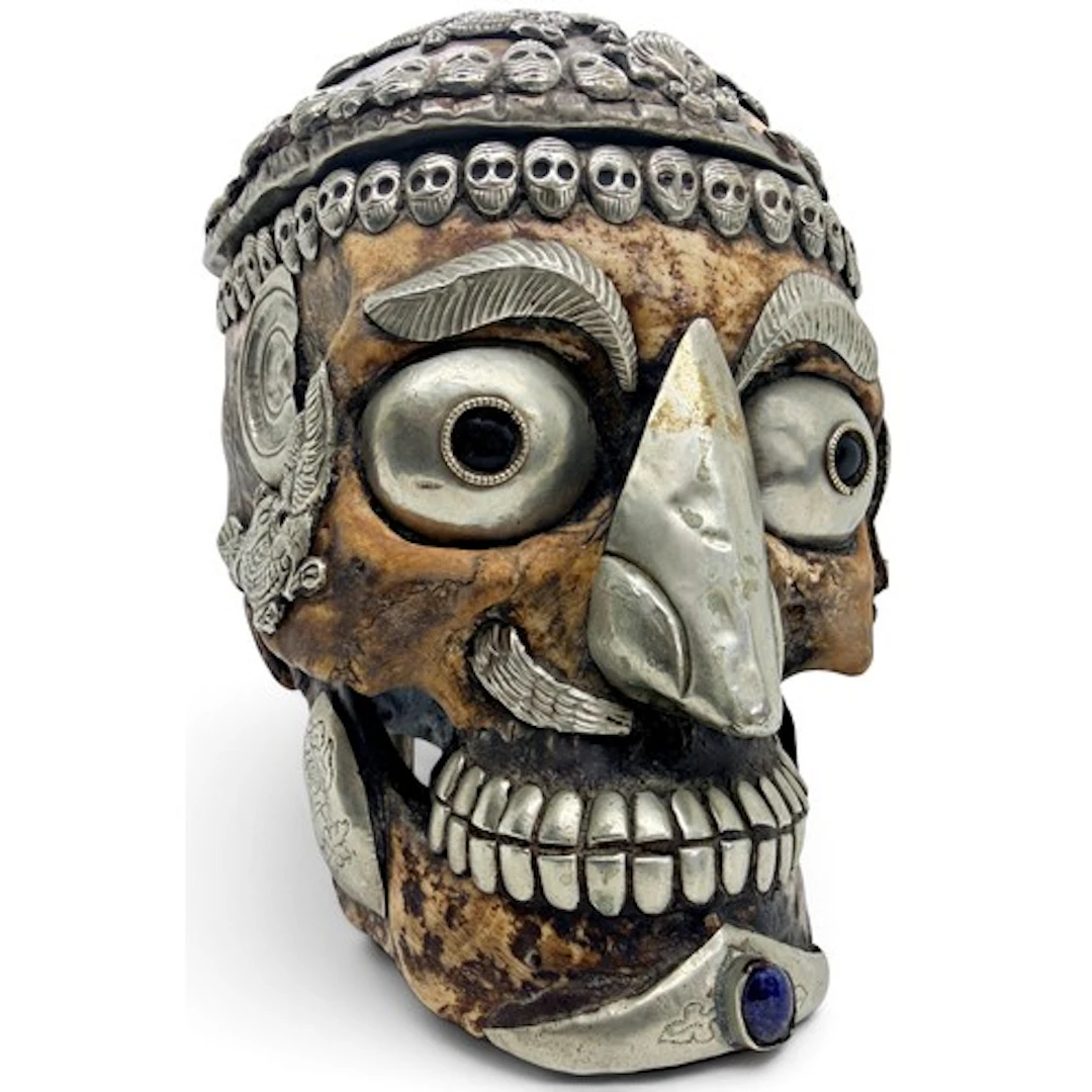 A Tibetan Kapala human skull with white metal and cabochon g...