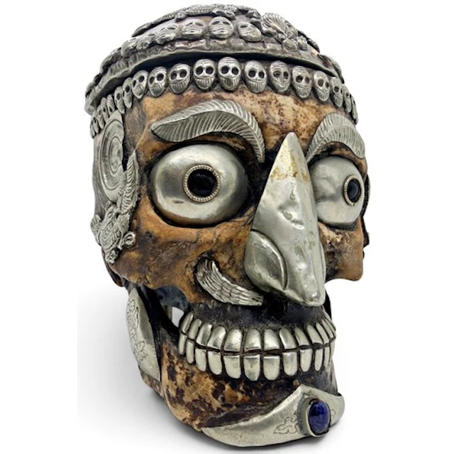 A Tibetan Kapala human skull with white metal and cabochon g...