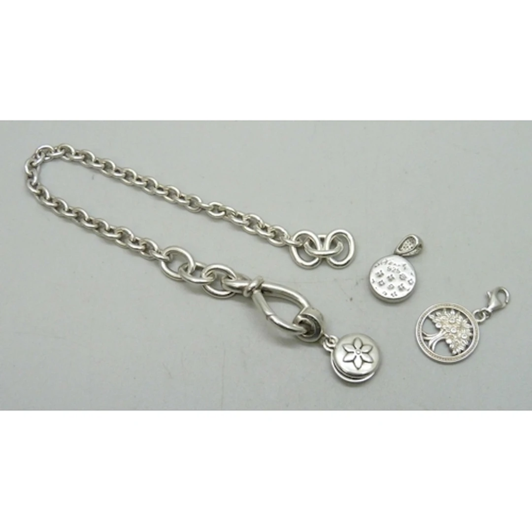 A Pandora silver bracelet with a Pandora charm, and two othe...