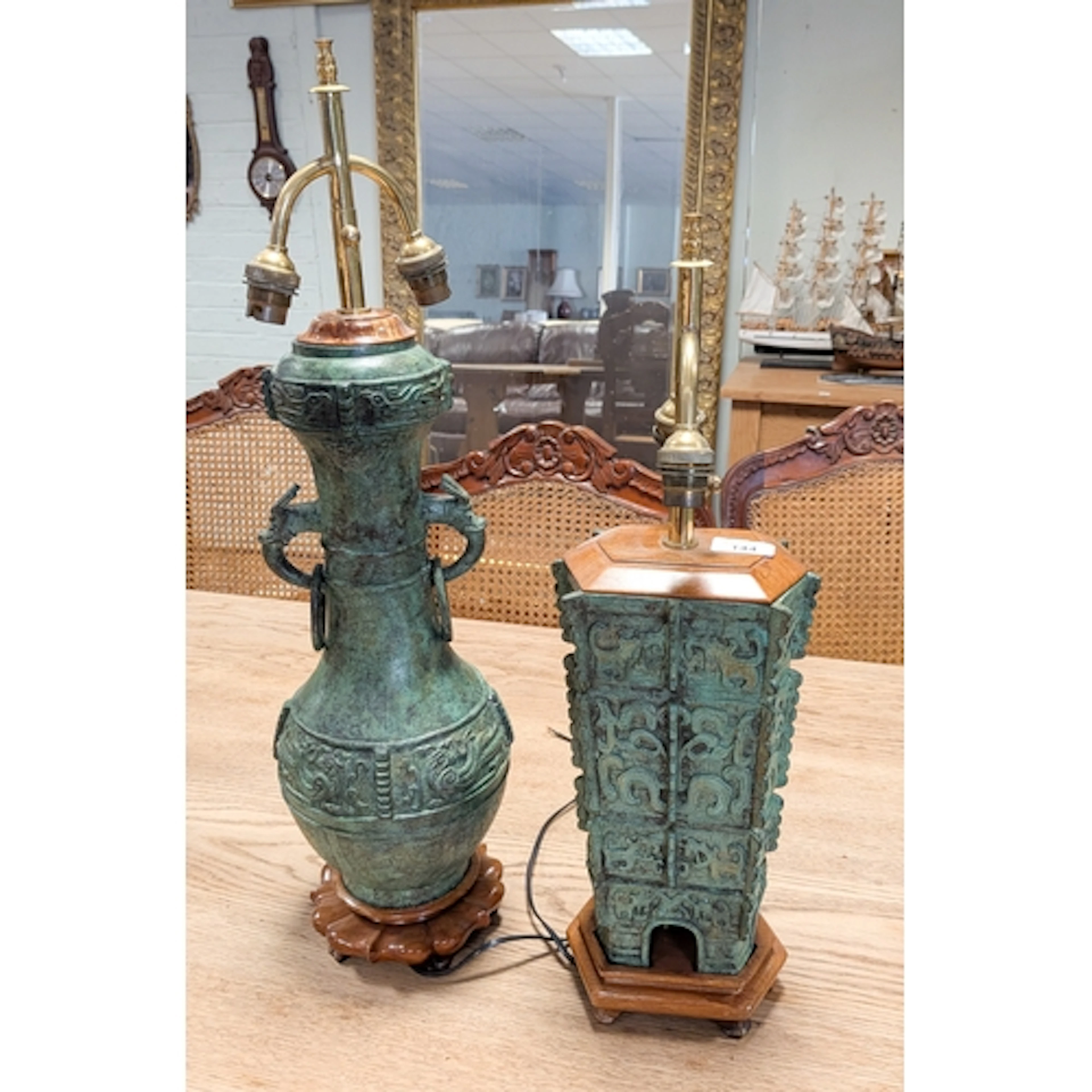 A pair of oriental bronze Verdigris table lamps on wooden b...