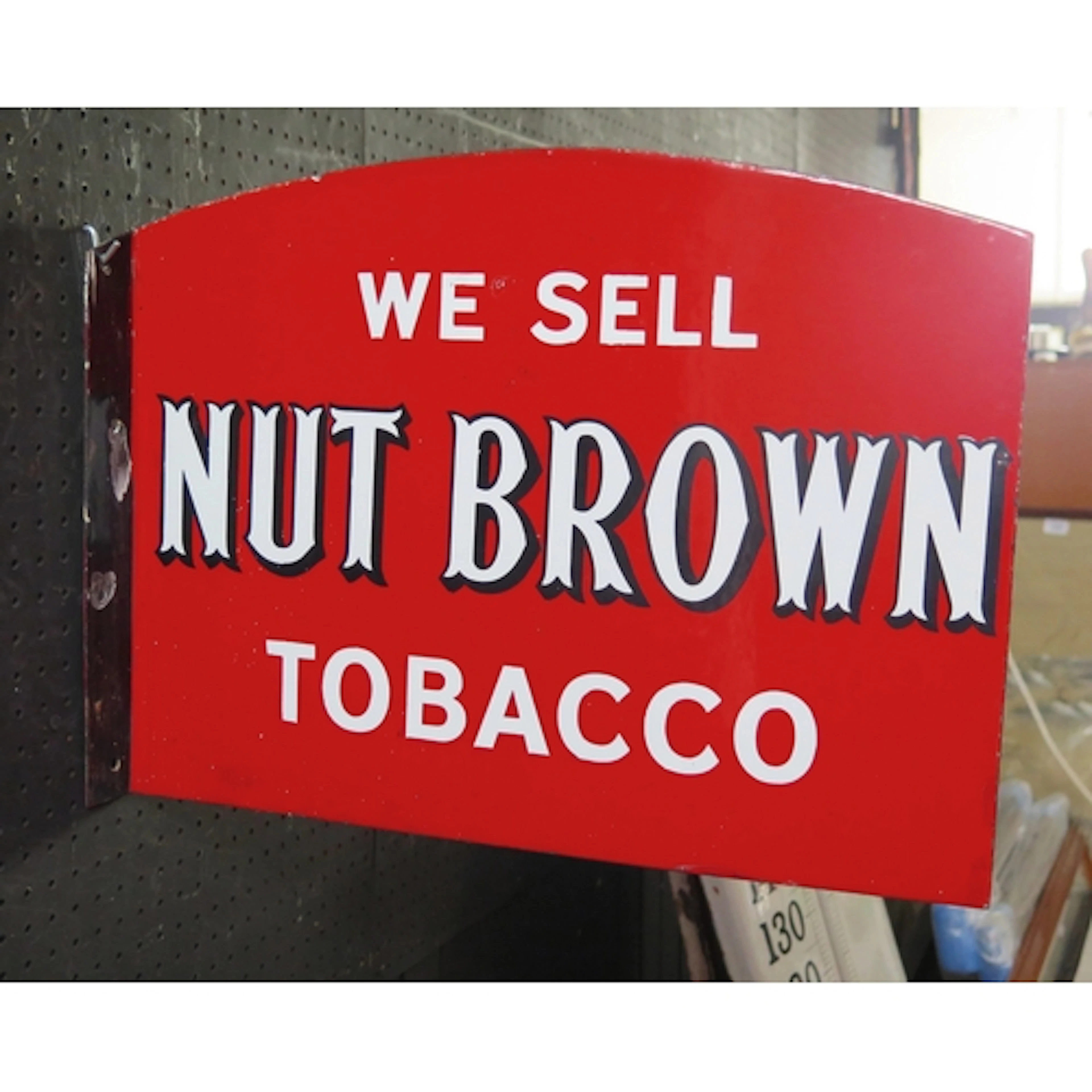 "We Sell Nut Brown Tobacco" - an enamel double-sided adverti...