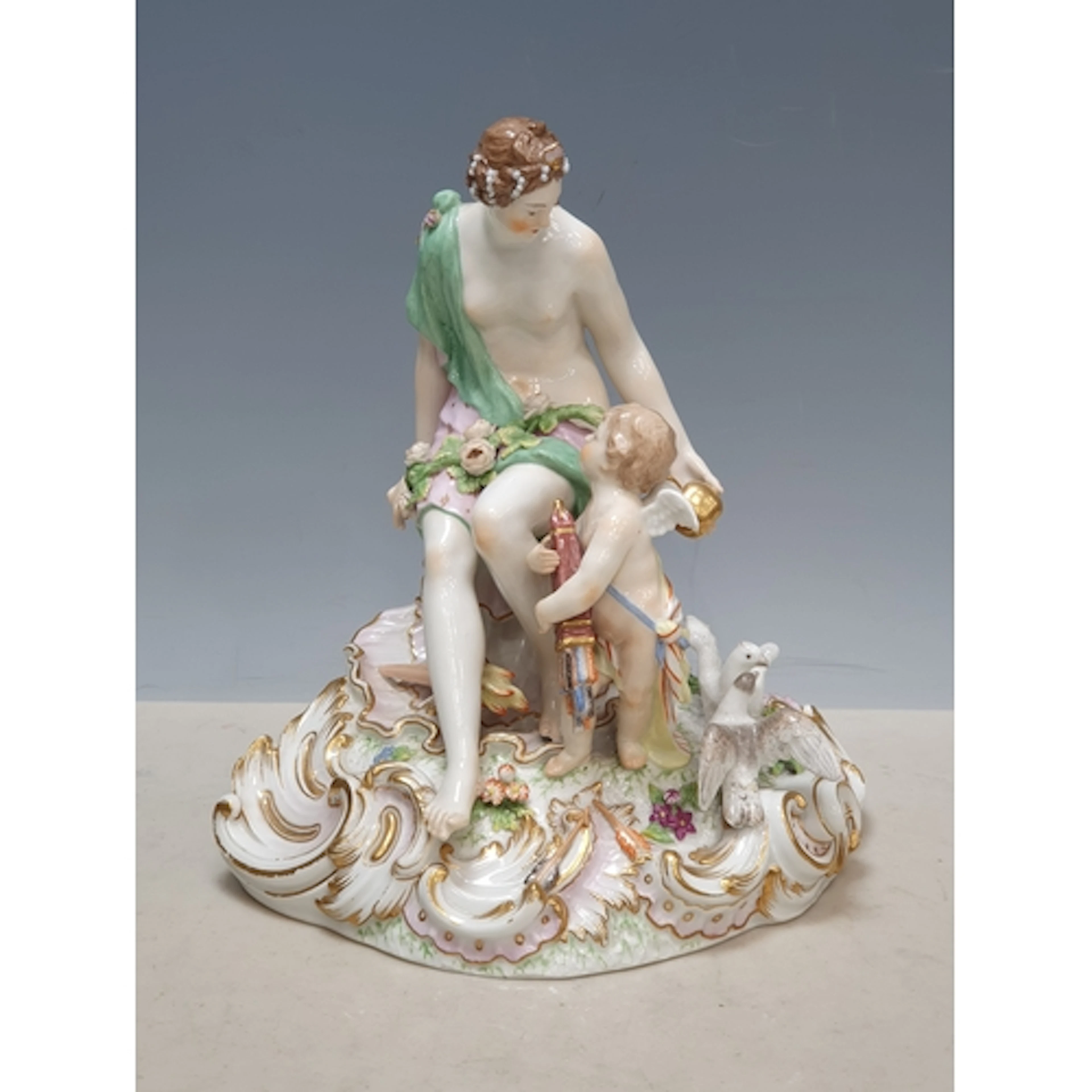 A KPM Berlin porcelain Figure of a scantily clad woman holdi...