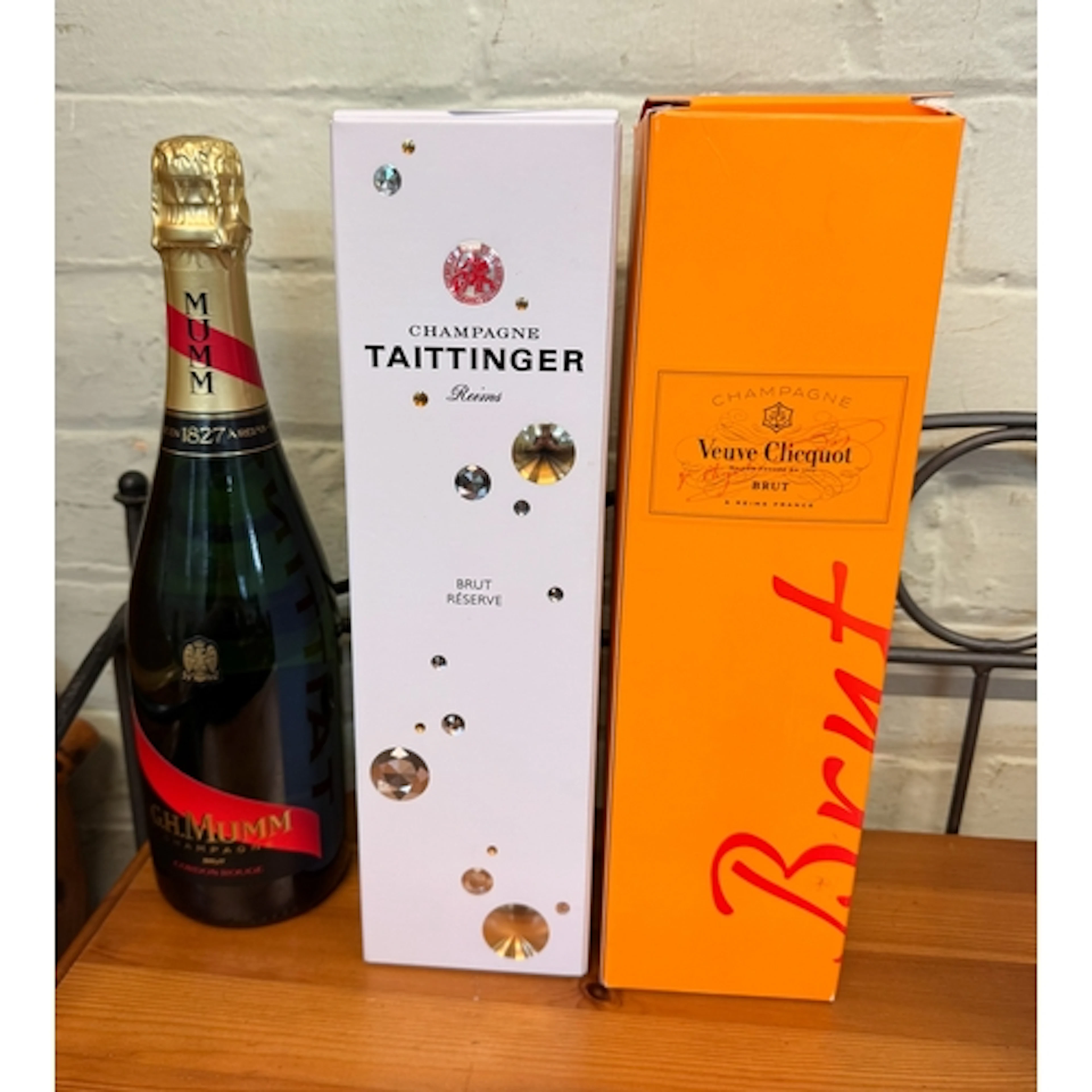 A bottle of Taittinger Champagne together with a bottle of V...