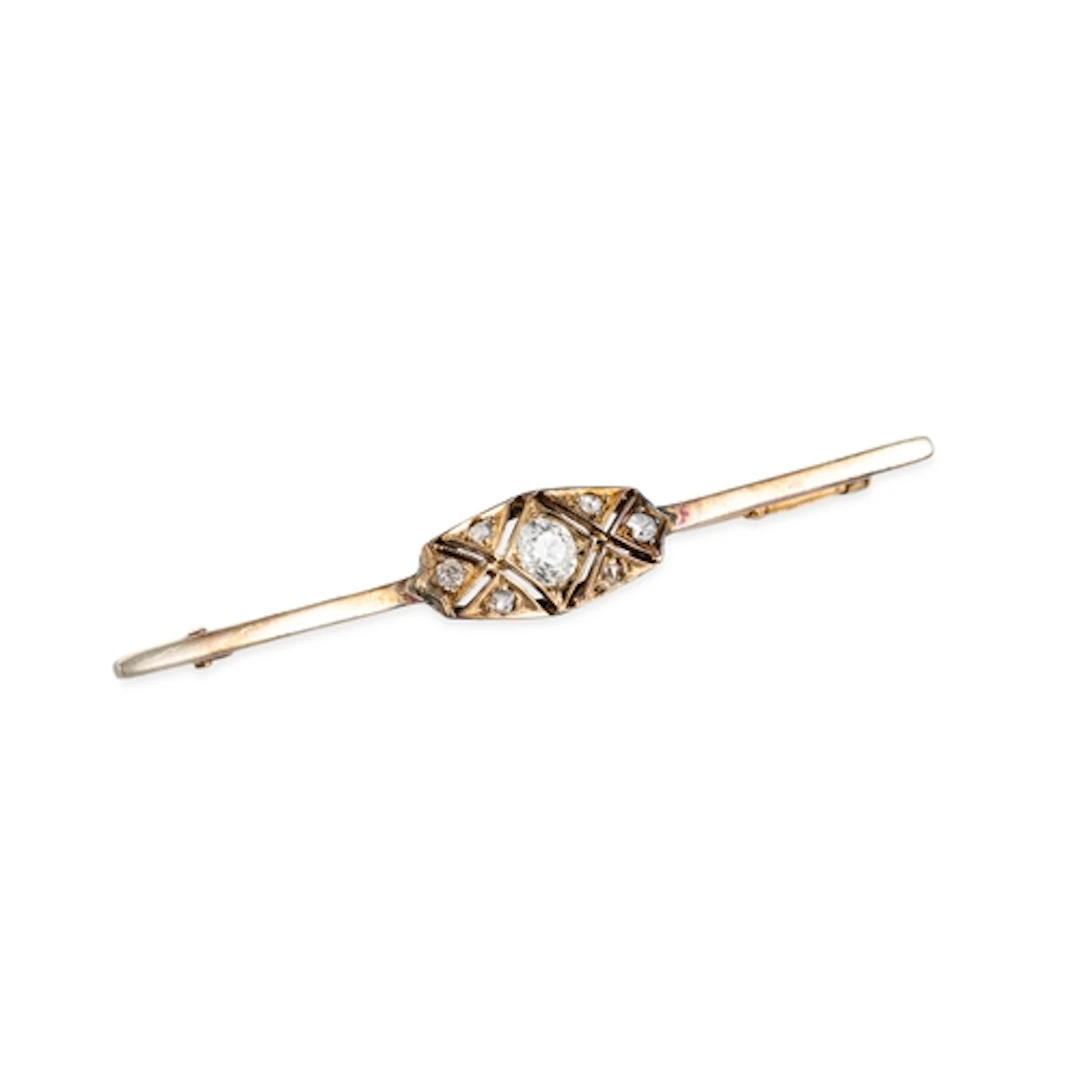A VINTAGE DIAMOND SET BAR BROOCH, the old cut diamonds mount...