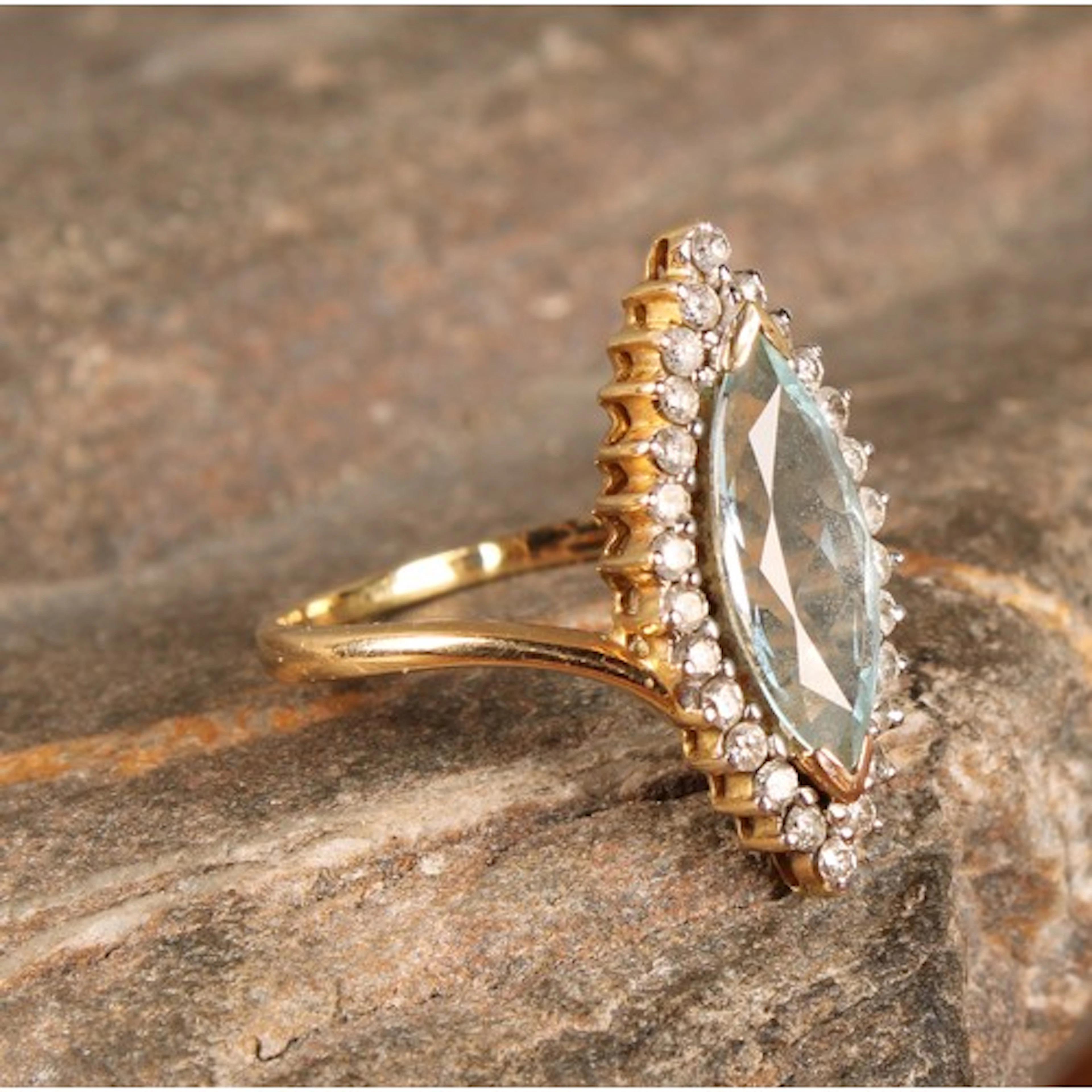 A Lorique 18ct gold aquamarine and diamond ring, navette cut...