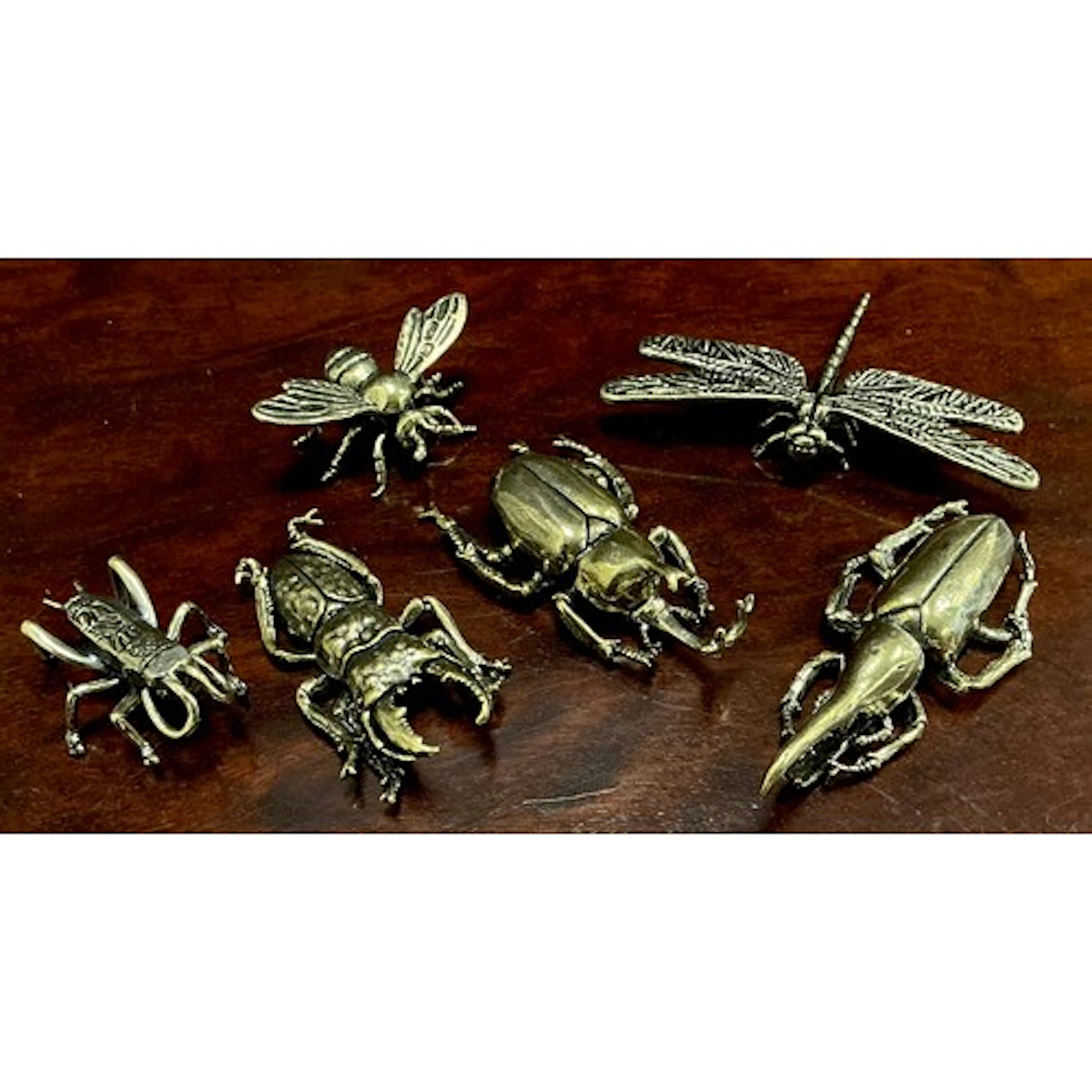 A collection of six cast gilt effect metal desk ornaments of...