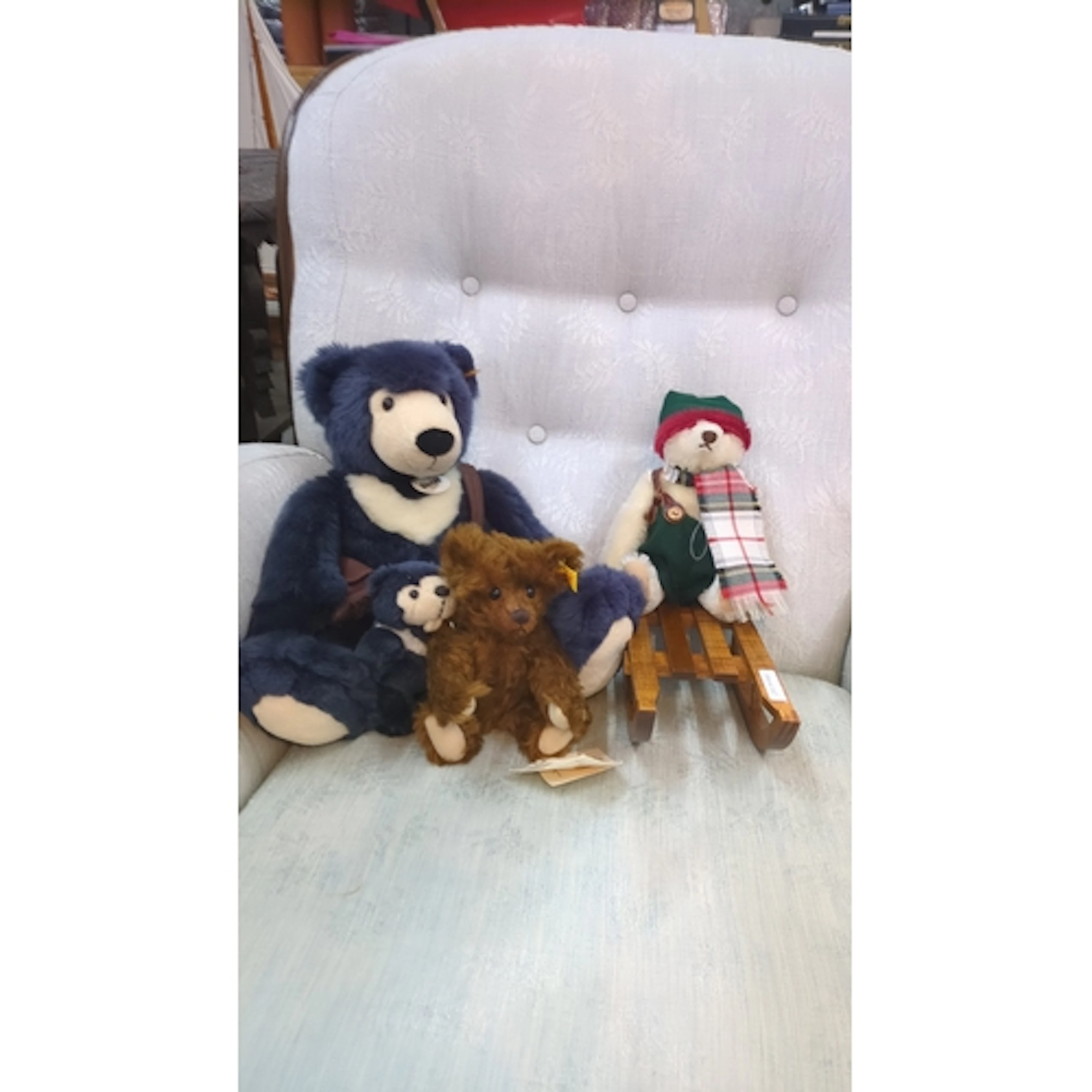 Four Steiff plush teddy bears including a navy mohair exampl...