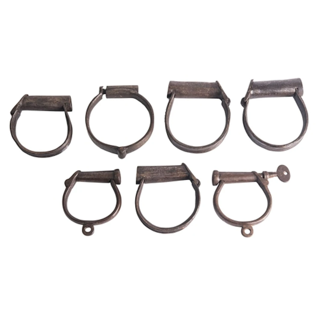 A pair of Hiatt-Darby style handcuffs (lacking chain) togeth...