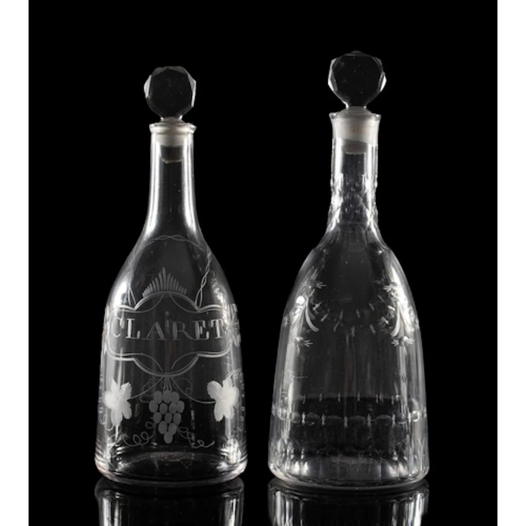 Two late 18th Century glass mallet-shaped decanters and stop...