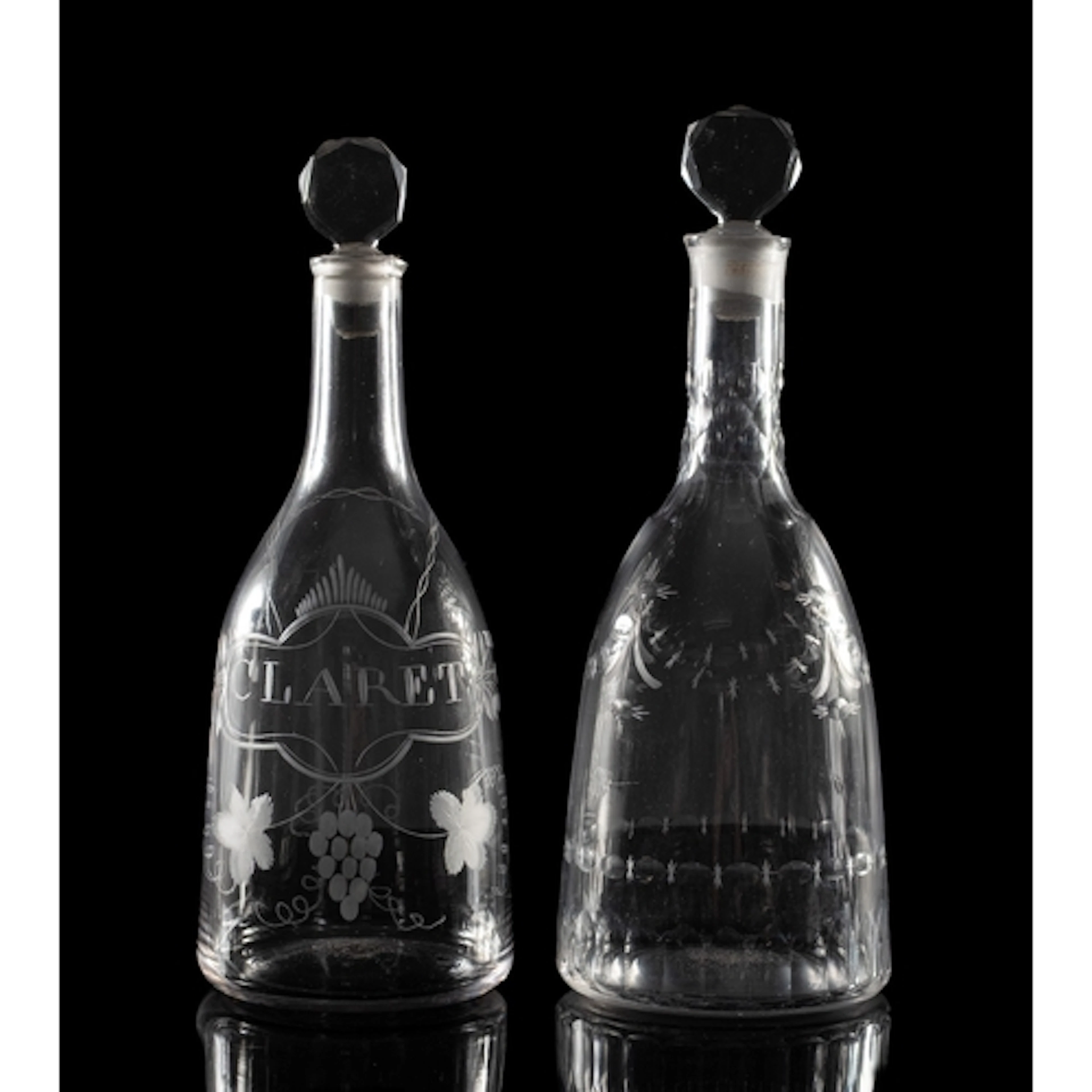 Two late 18th Century glass mallet-shaped decanters and stop...