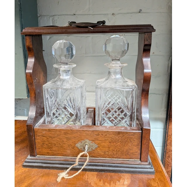 A modern two bottle spirit tantalus complete with key