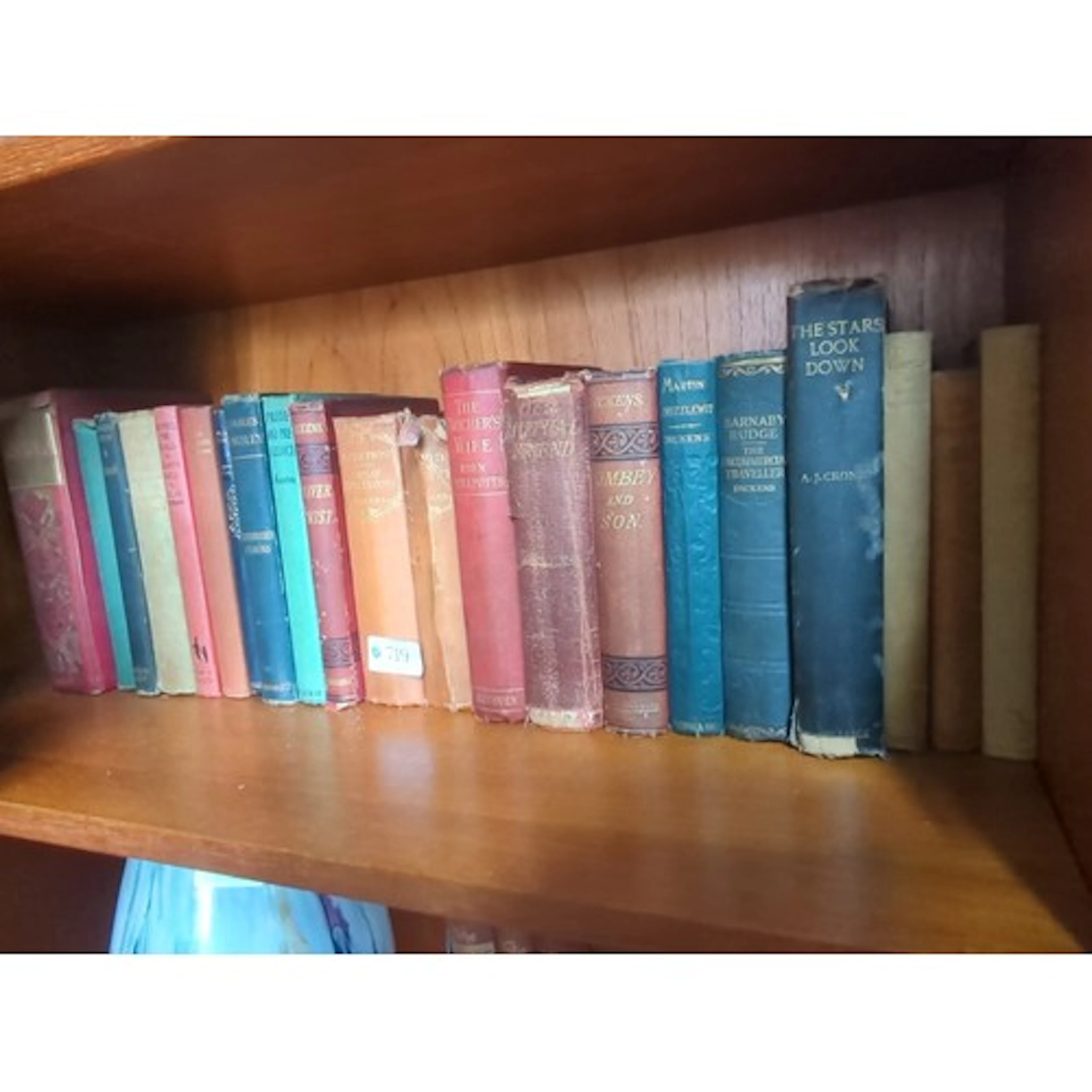 A collection of cloth-bound books, including Charles Dickens...