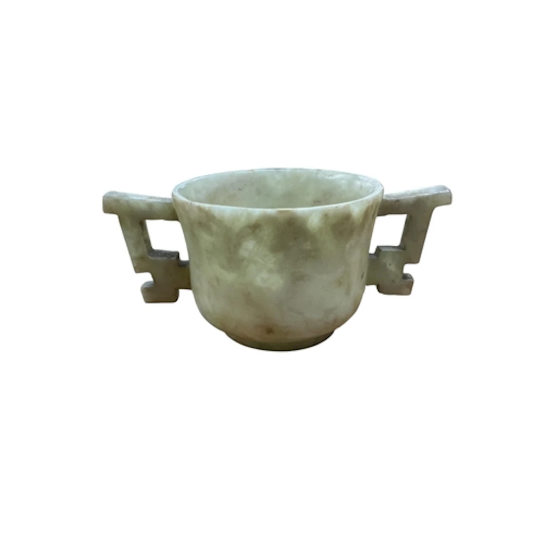 A Chinese bowenite jade two handled cup, 9.5cm wide