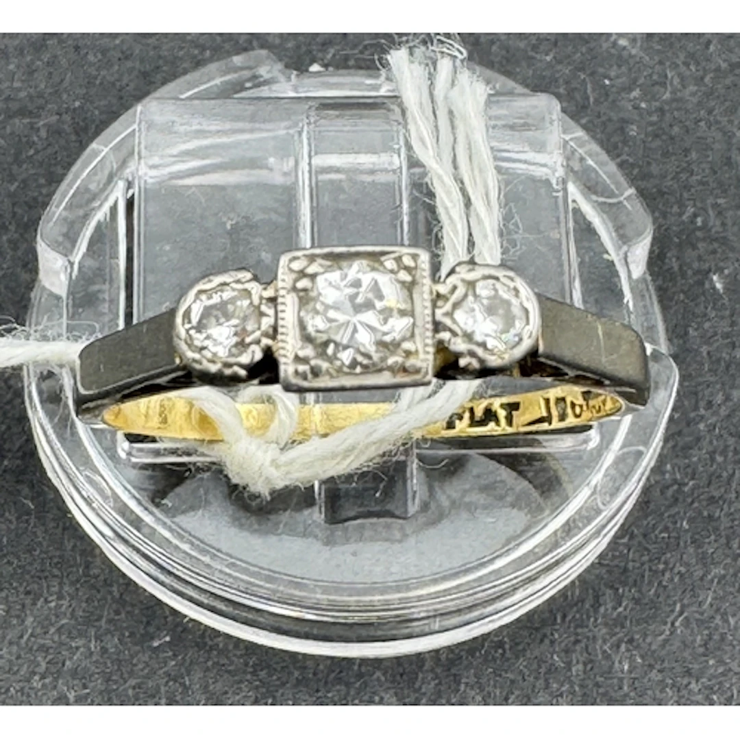 Jewellery: Yellow metal ring, set in white metal, with three...