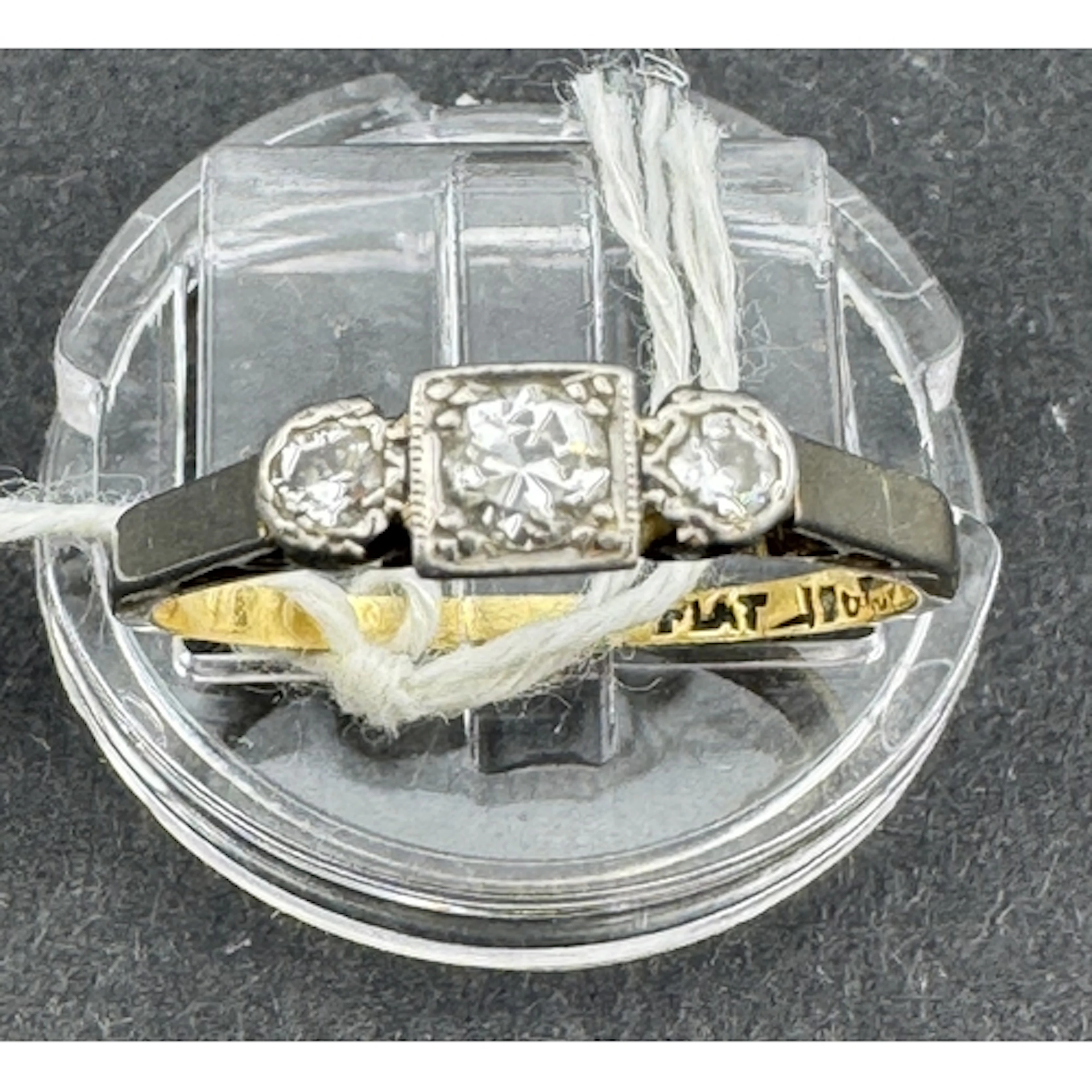 Jewellery: Yellow metal ring, set in white metal, with three...