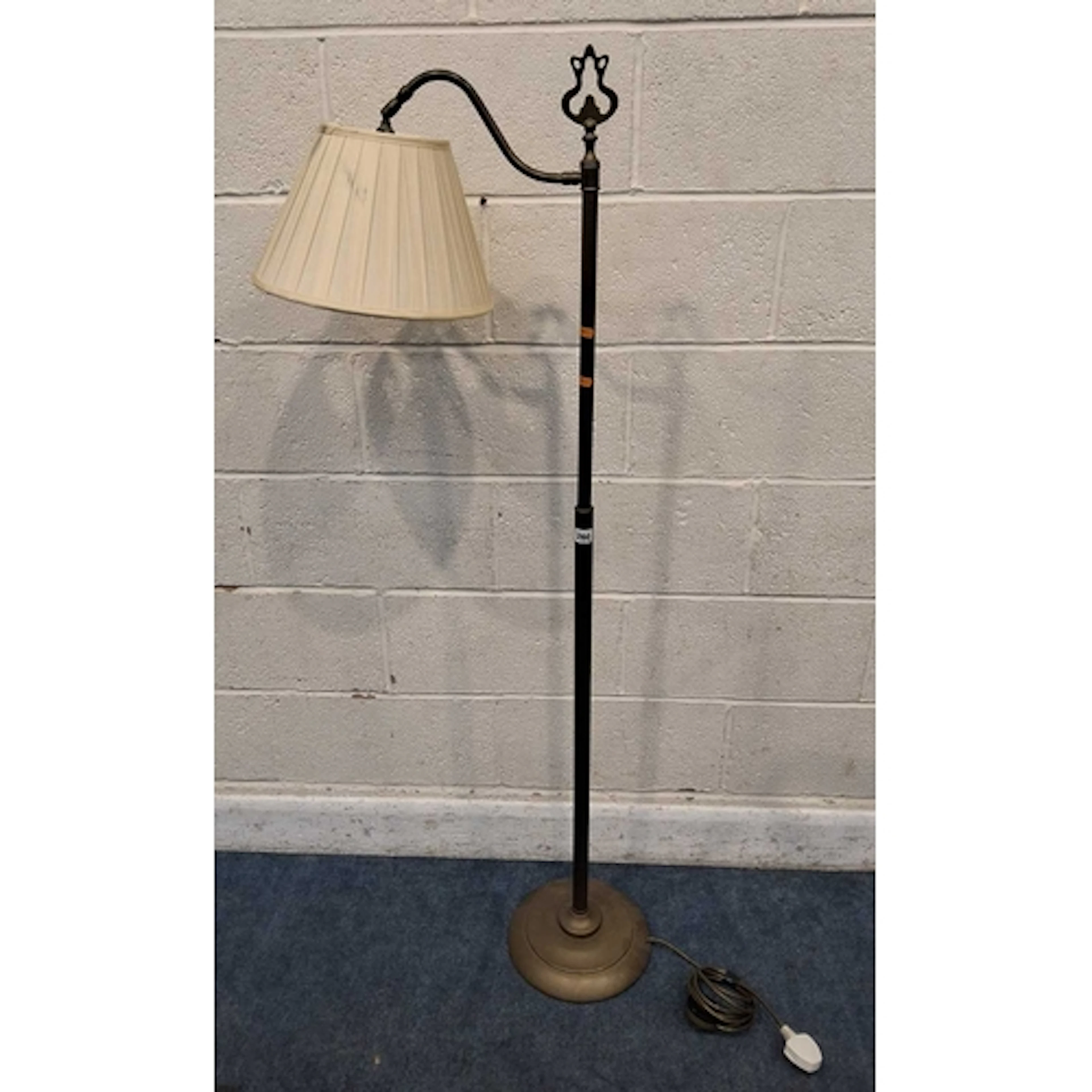 A LAURA ASHLEY BRASS STANDARD LAMP, with an adjustable light...