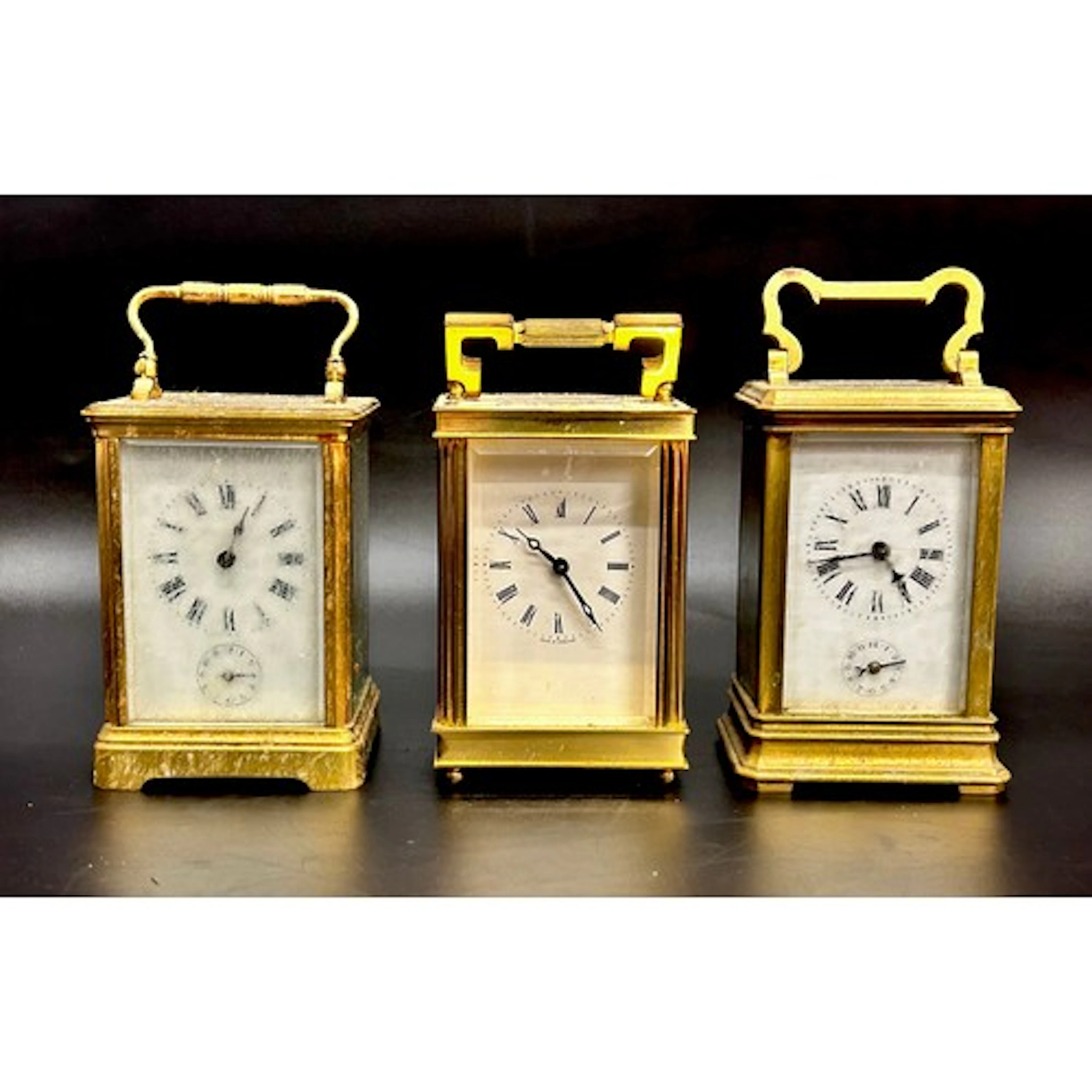 Three brass carriage clocks, one with a Lionel Peck movement...