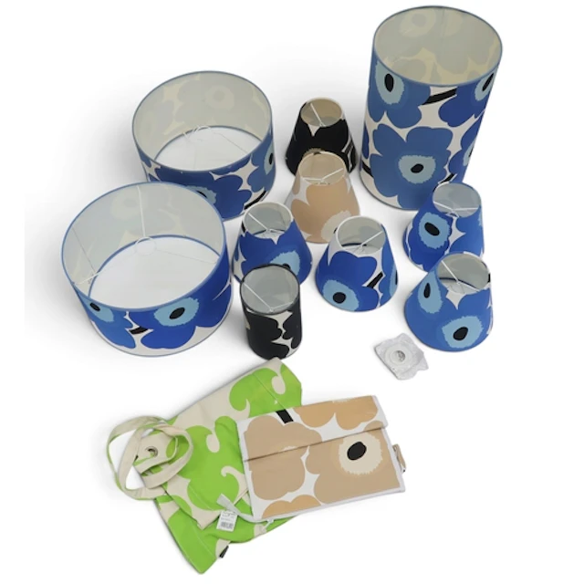 A collection of lampshades in Marimekko Unikko fabrics in bl...
