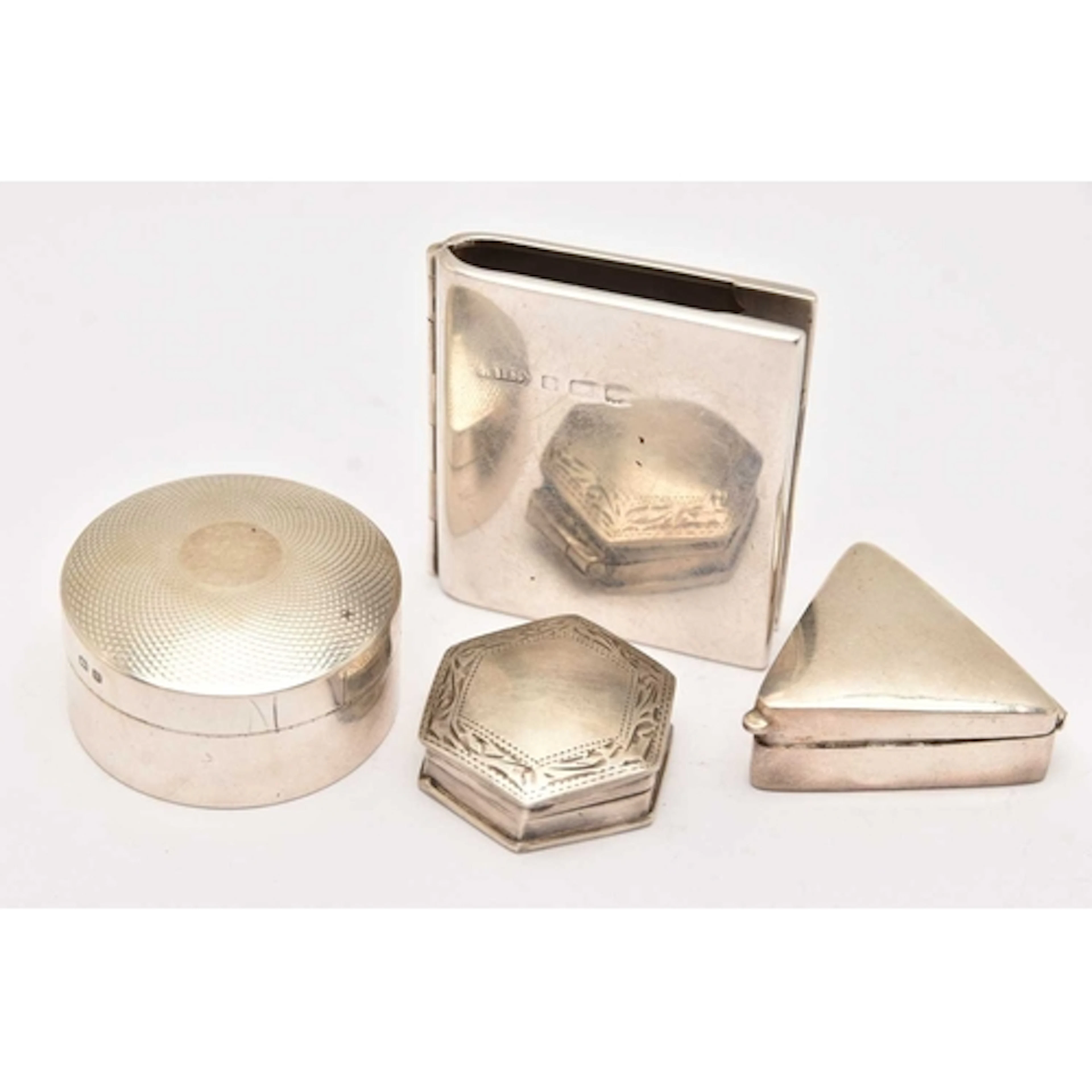 THREE SILVER/WHITE METAL TRINKET BOXES AND A STAMP HOLDER, t...