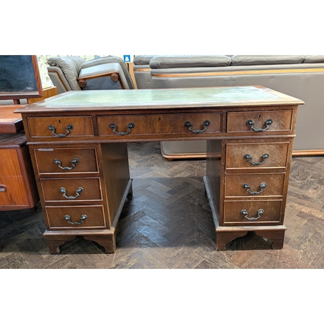 An Edwardian mahogany kneehole pedestal desk fitted nine dra...