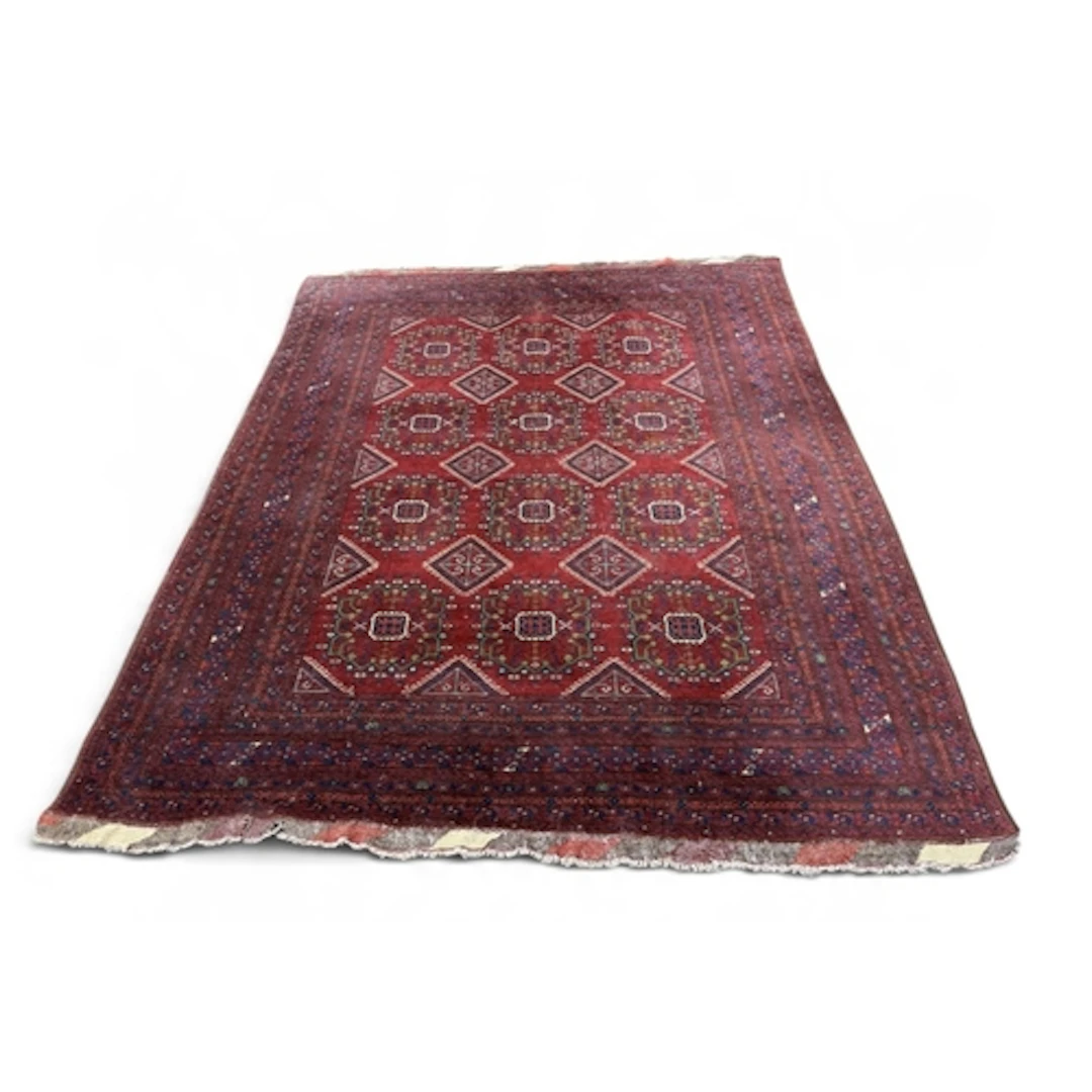 A KAYAM ORIENTAL RUG With four rows of medallians reserved a...