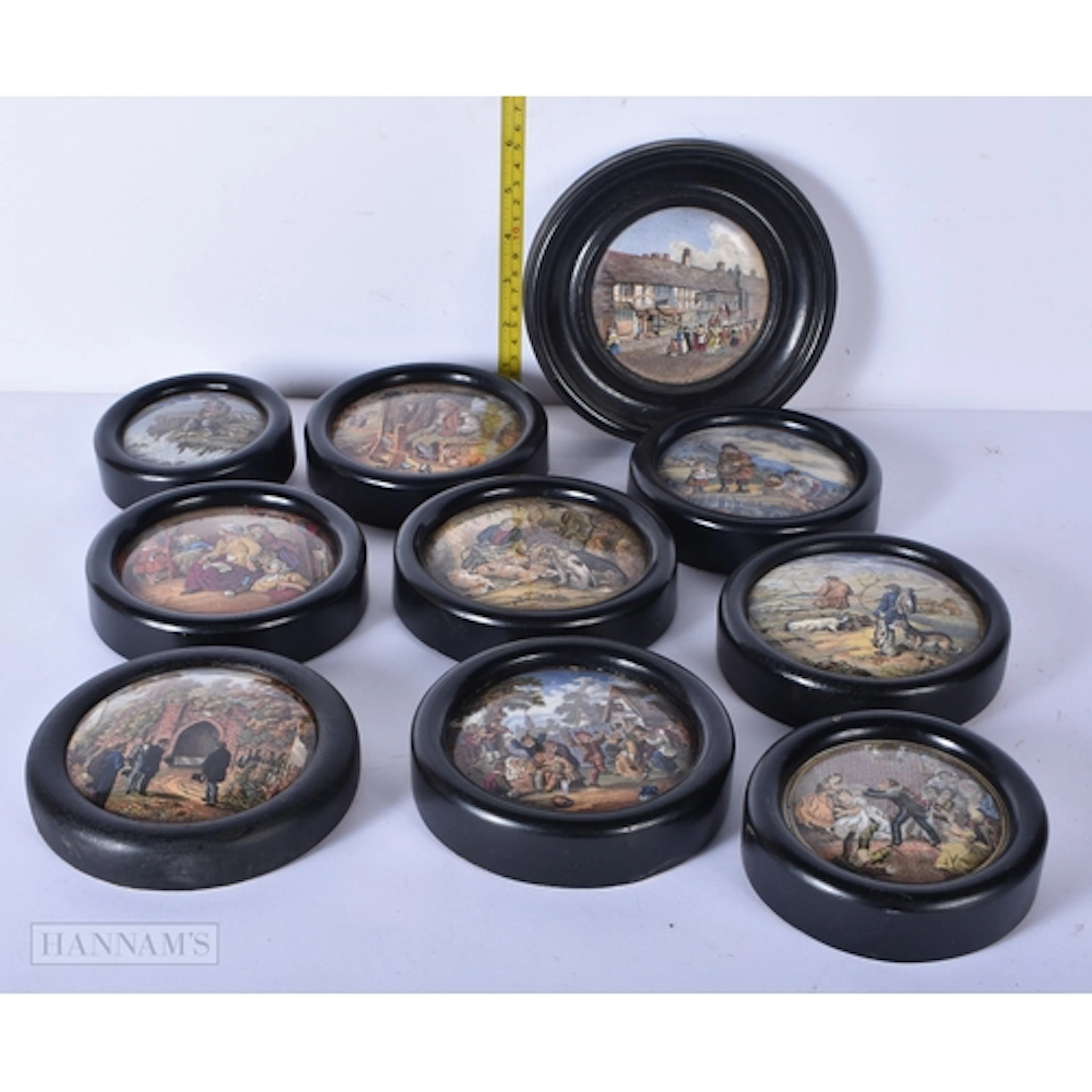 A collection of antique framed ceramic pot lids 16cm (10)