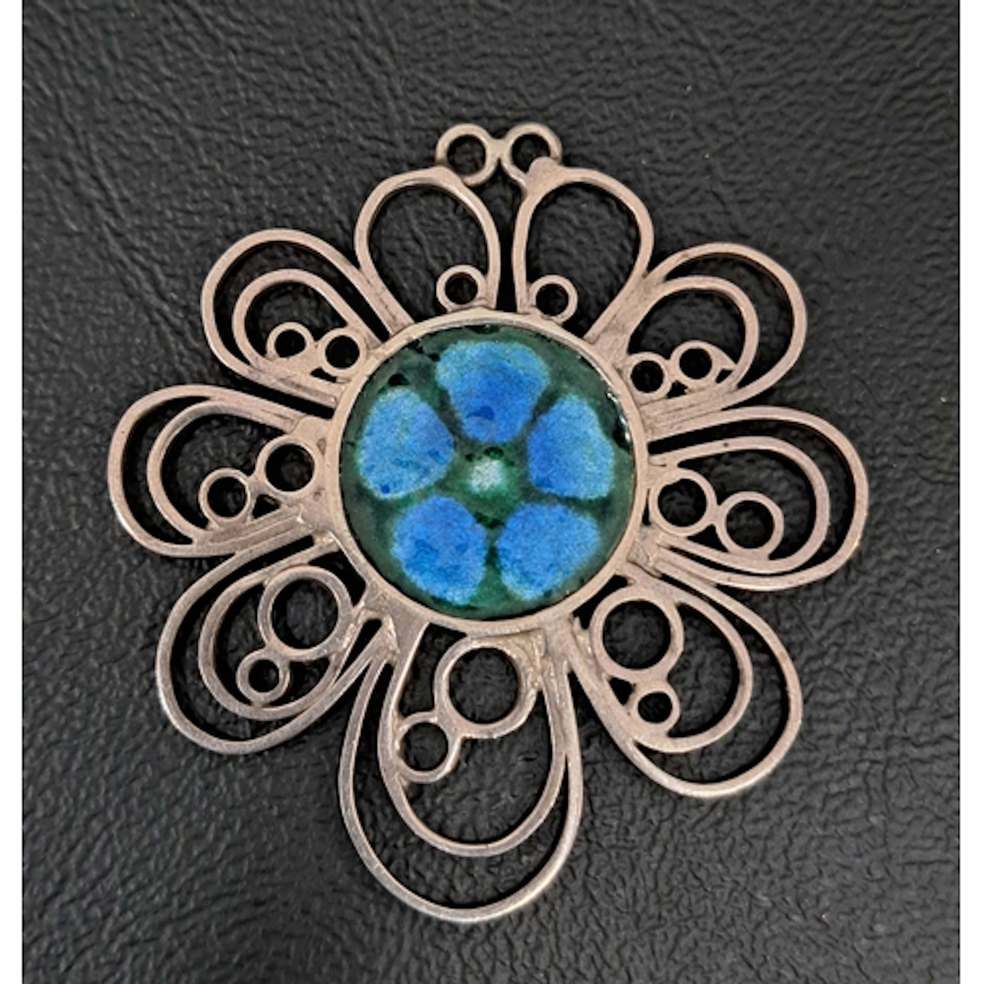 NORMAN GRANT SILVER AND ENAMEL FLOWER PENDANT the centre wit...