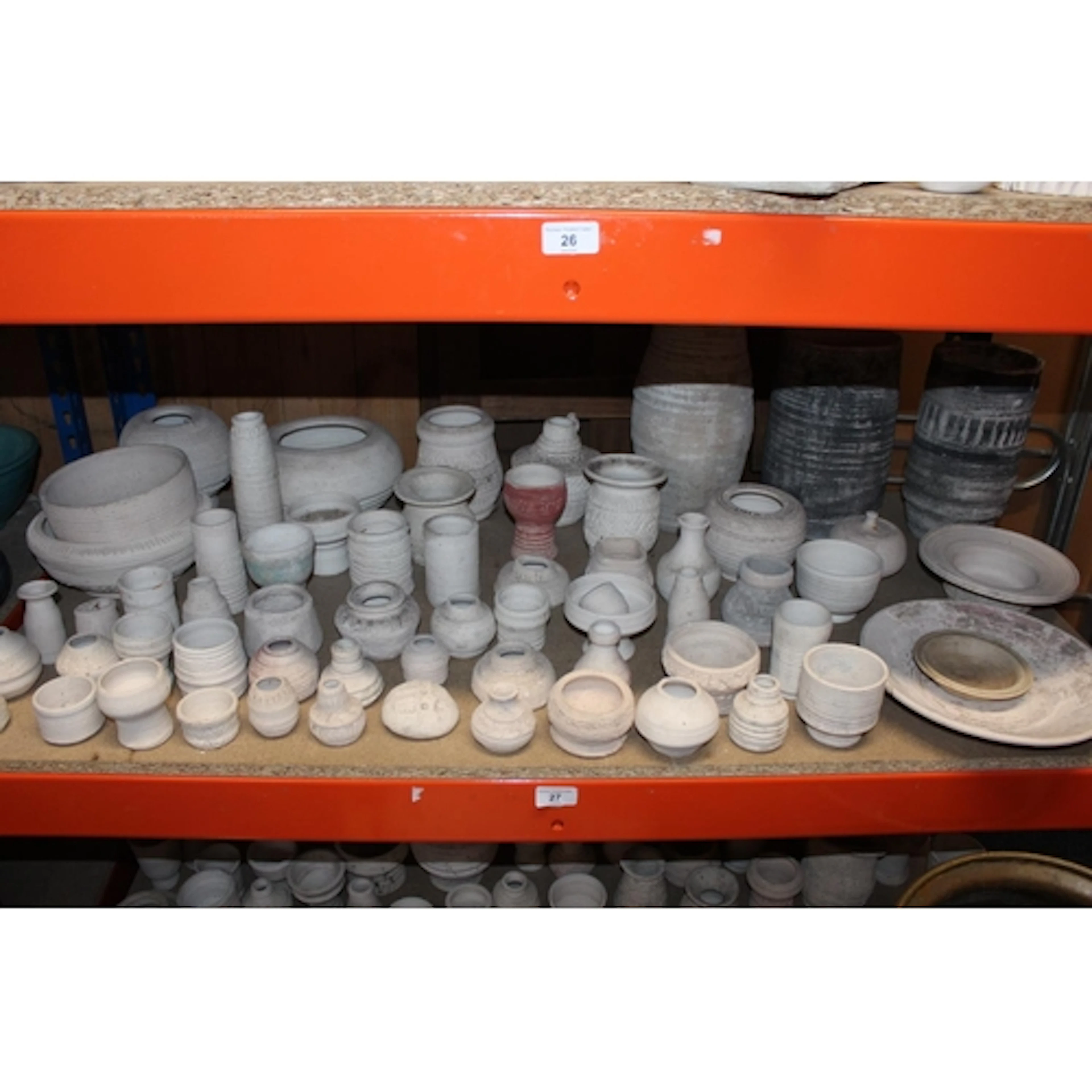 Shelf of unglazed Oxshott Pottery vases and bowls. Pro...