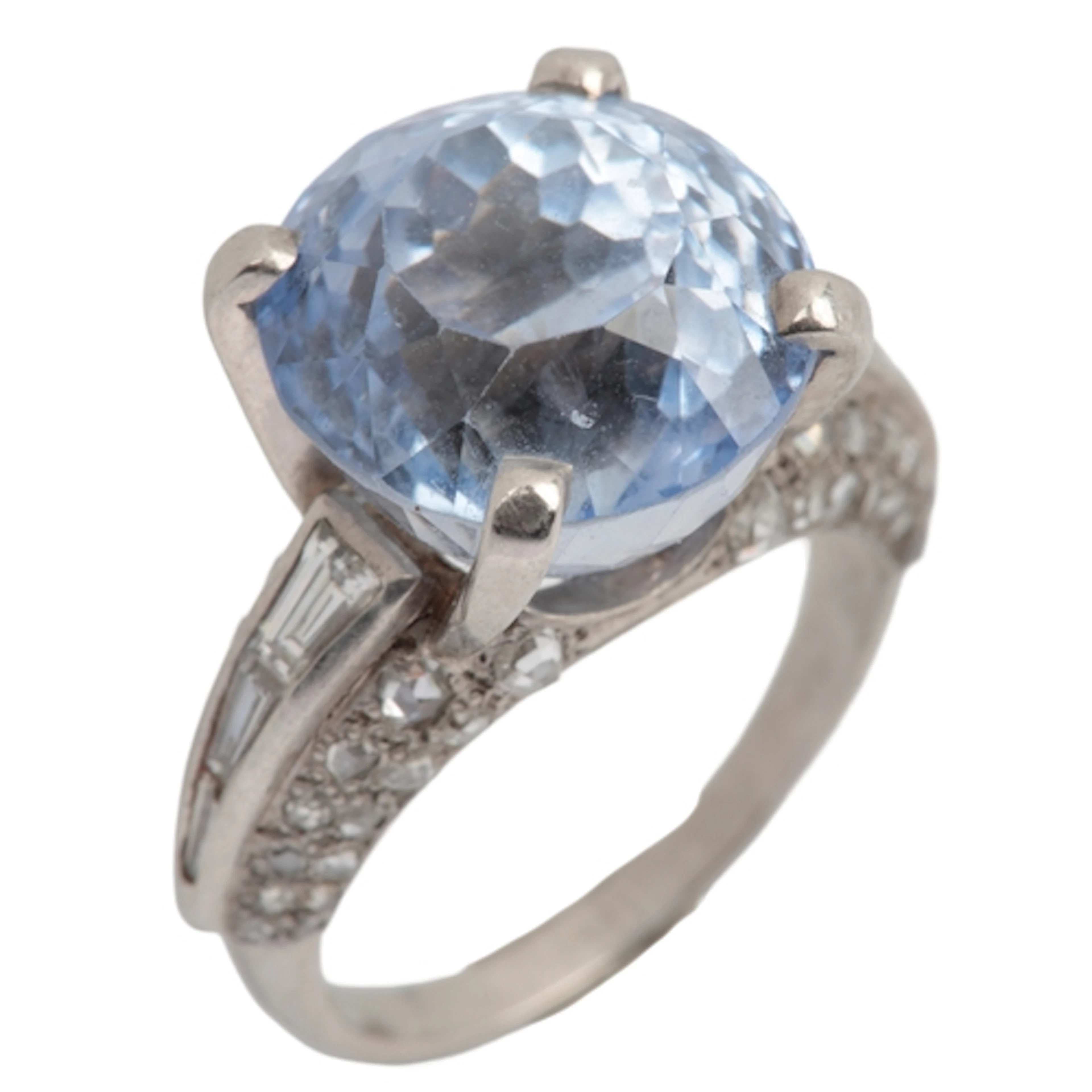 A sapphire and diamond ring, claw-set with a circular-cut sa...