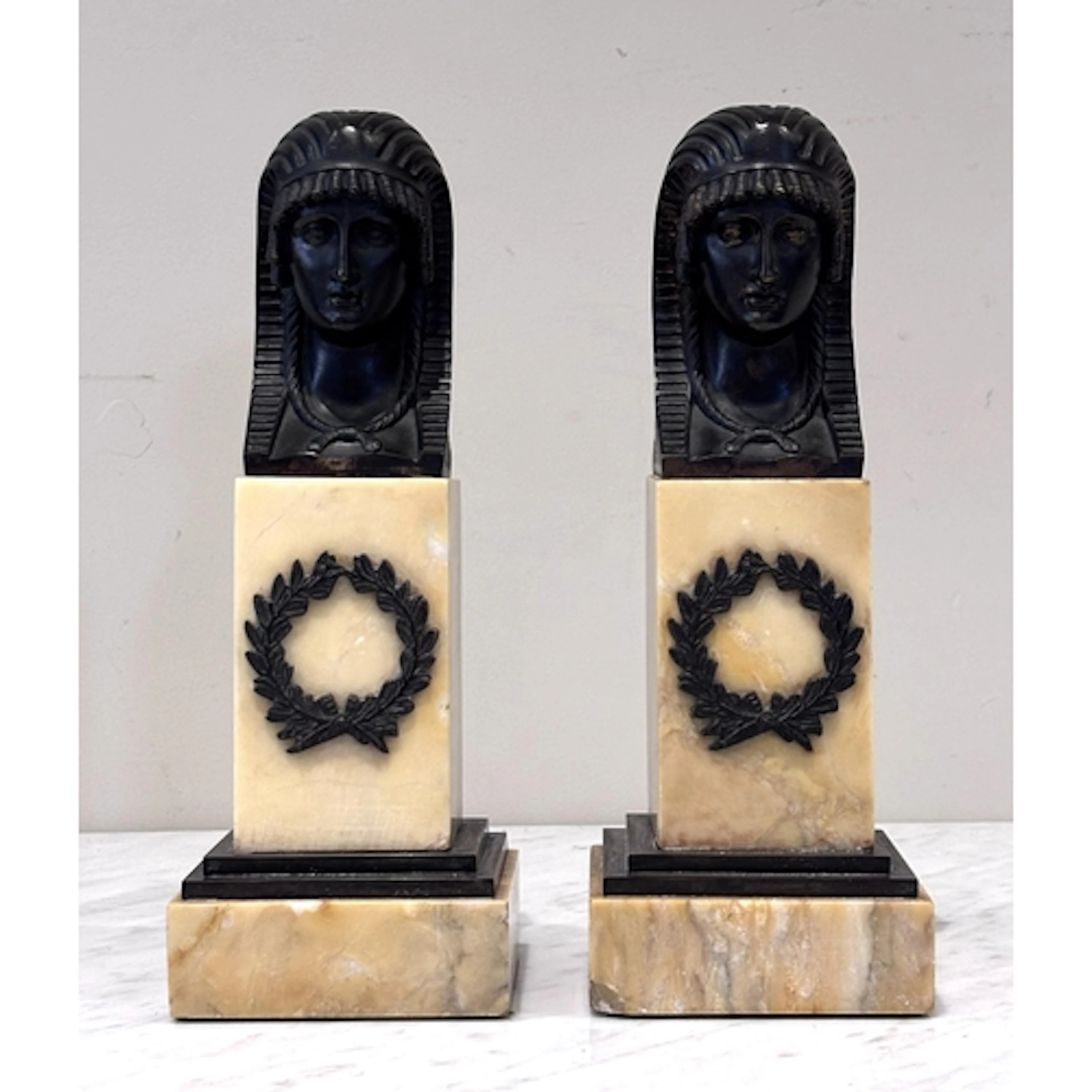 A pair of Egyptian Revival patinated bronze busts, early 20t...