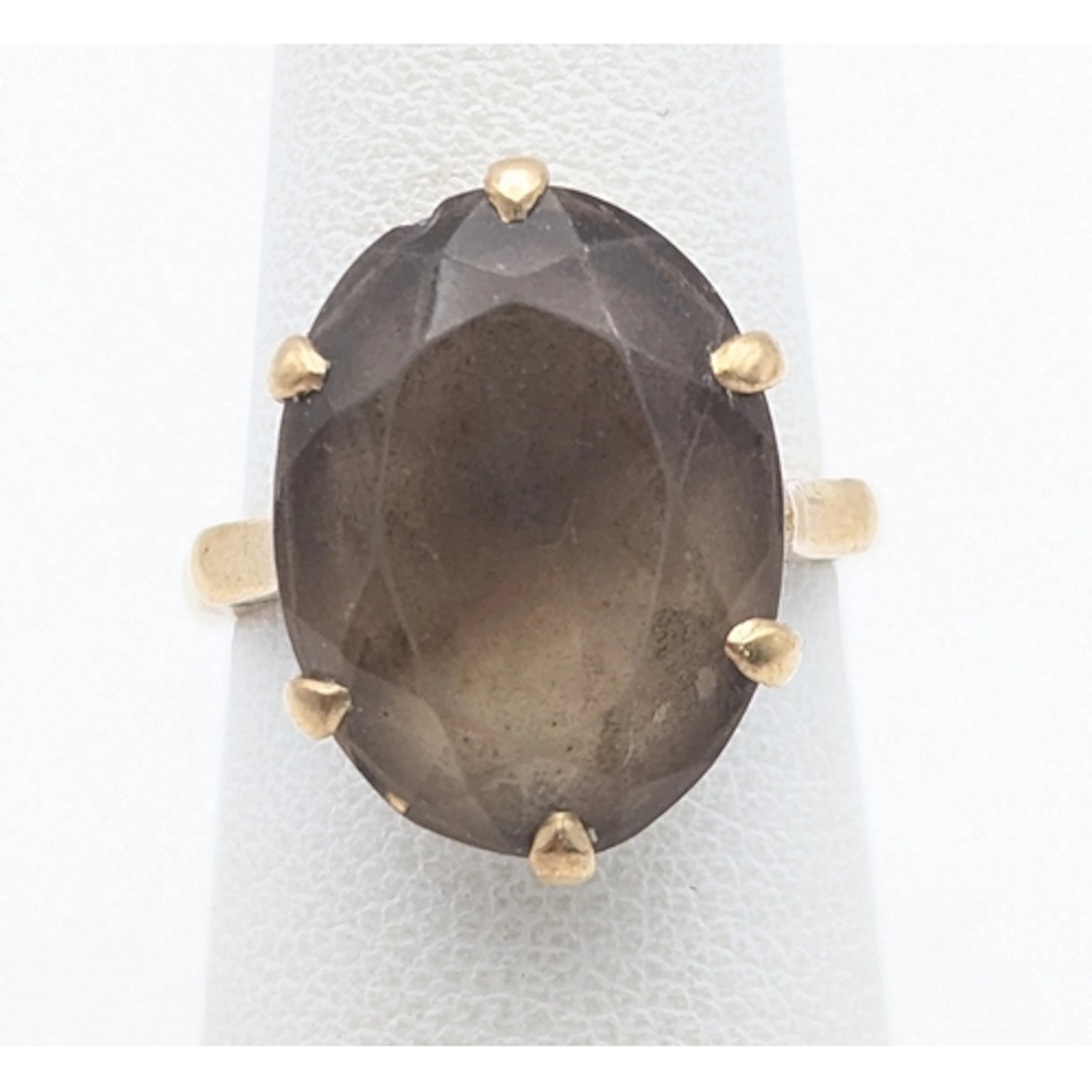 A 9ct yellow gold and claw set oval cut smoky quartz ring Lo...