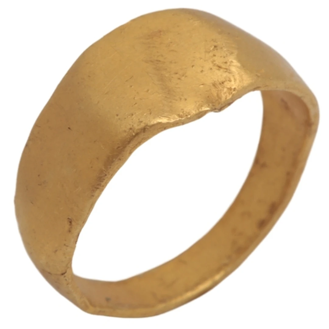 A Medieval child's signet ring, centring on a circular matri...