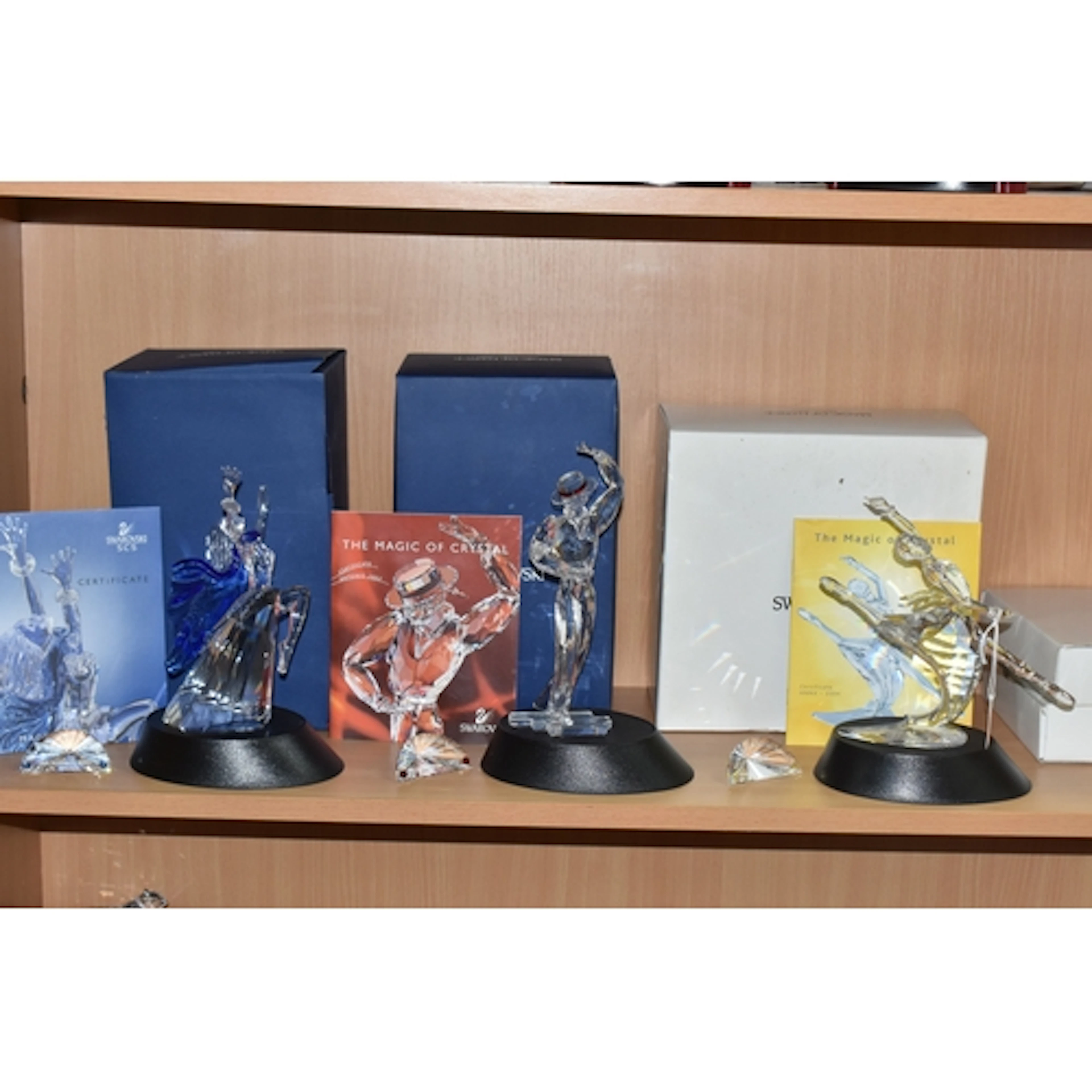 A BOXED SWAROVSKI CRYSTAL MAGIC OF DANCE TRILOGY OF FIGURES,...