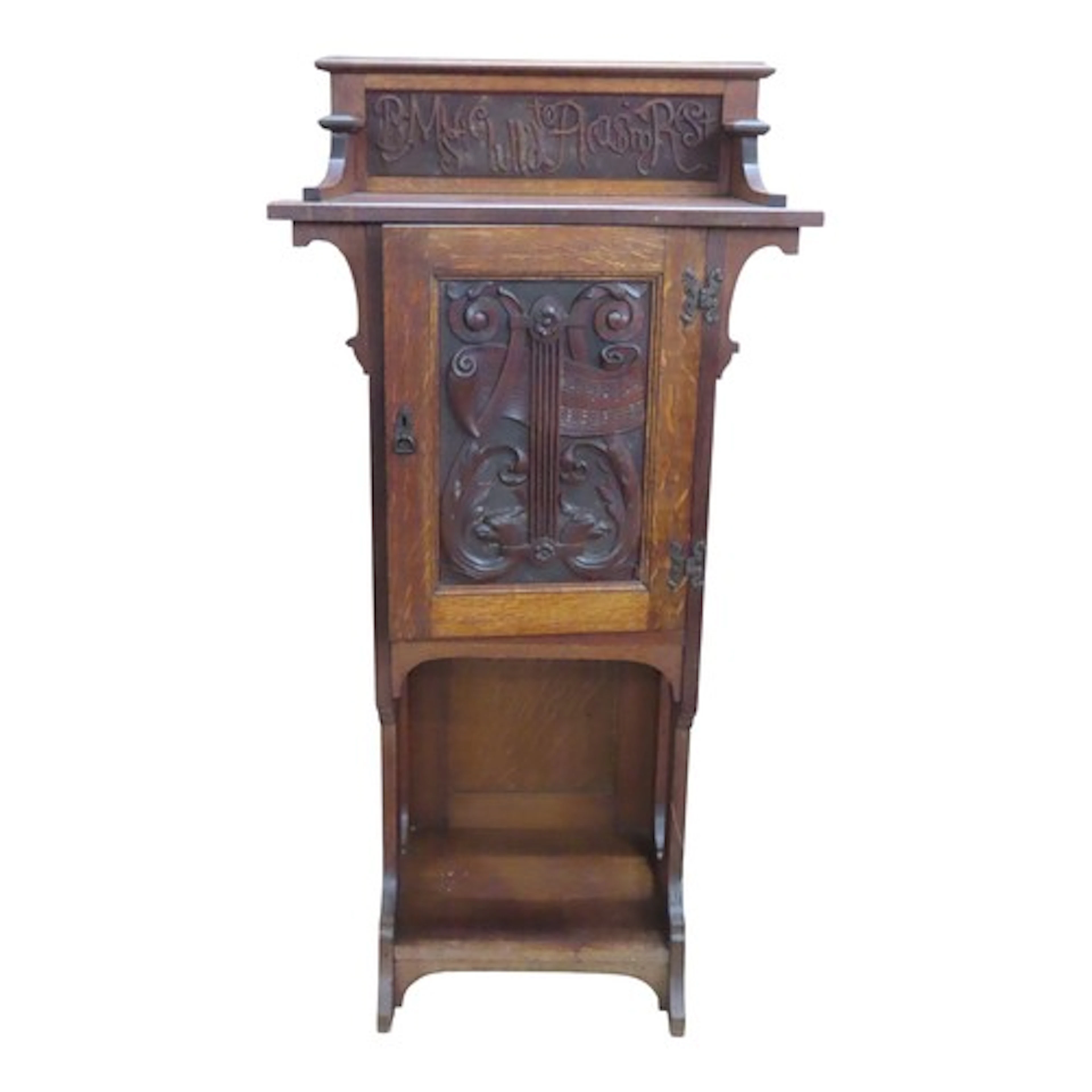 An Arts and Crafts style music cabinet in oak with a panel d...