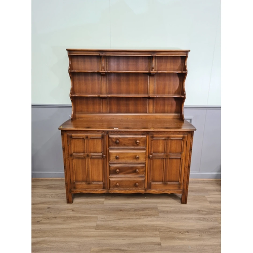 An Ercol Dresser and Rack fitted four central drawers flanke...