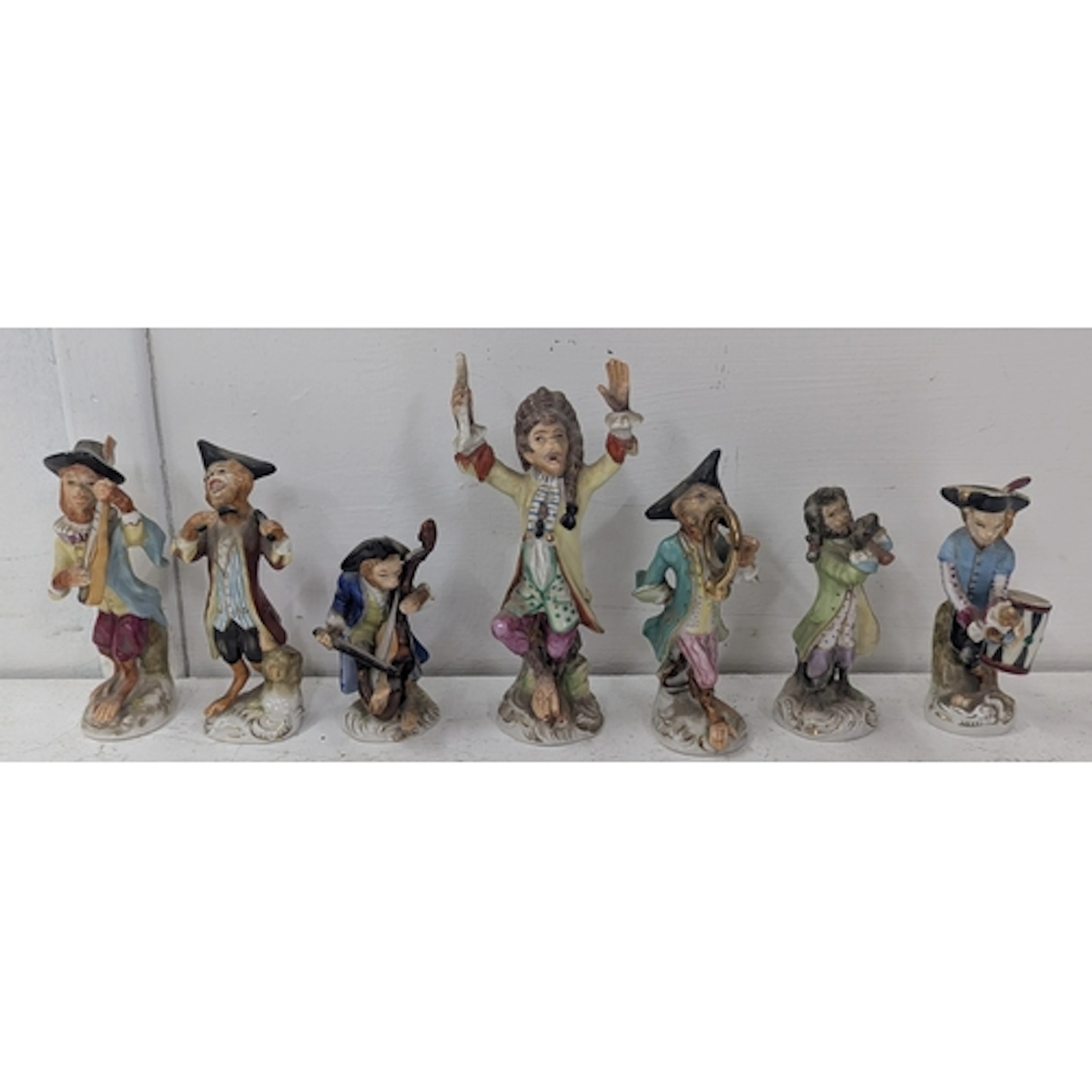 Seven ceramic monkey band/orchestra models to include the co...